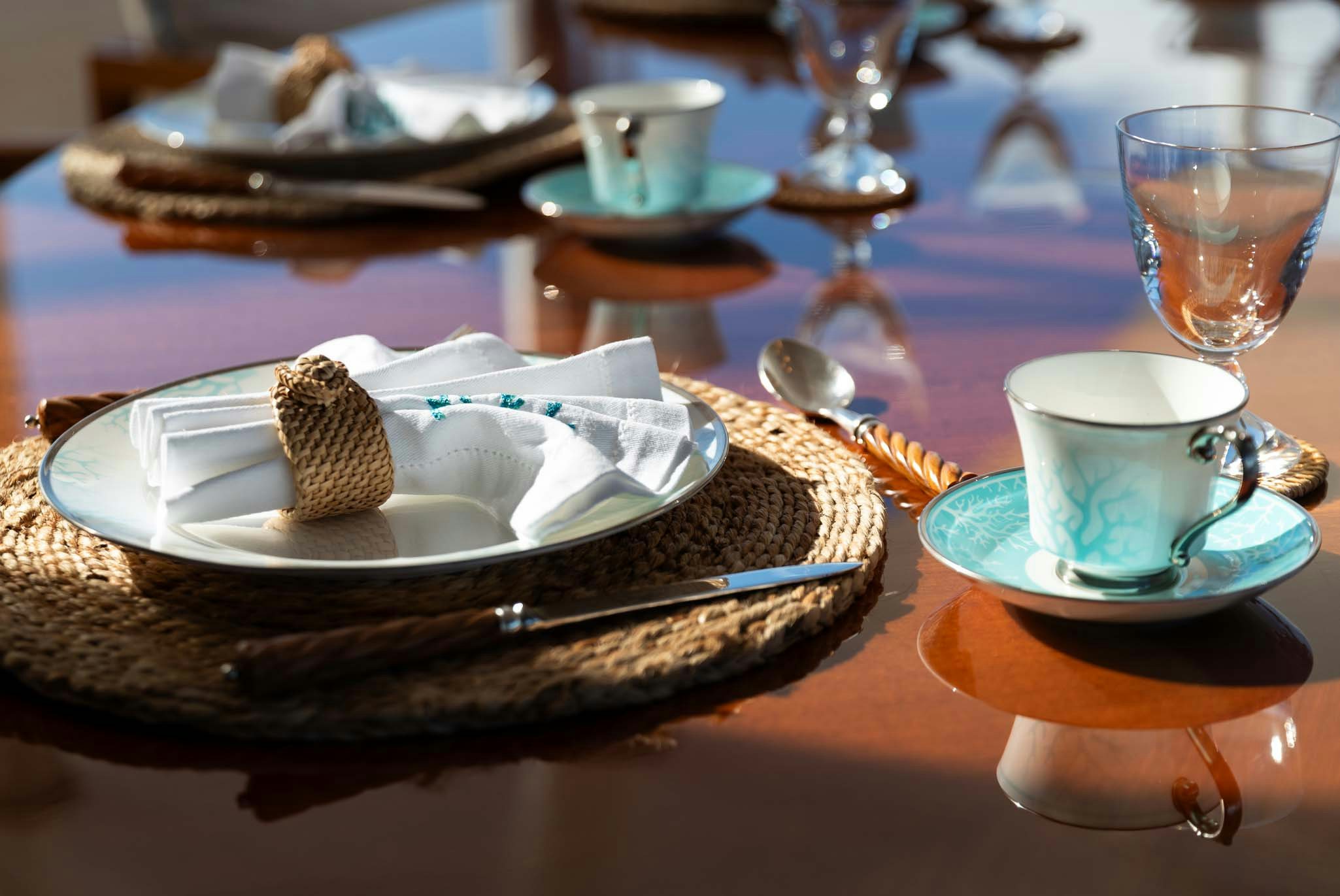 a plate of dessert and a glass of water aboard AXIOMA Yacht for Charter