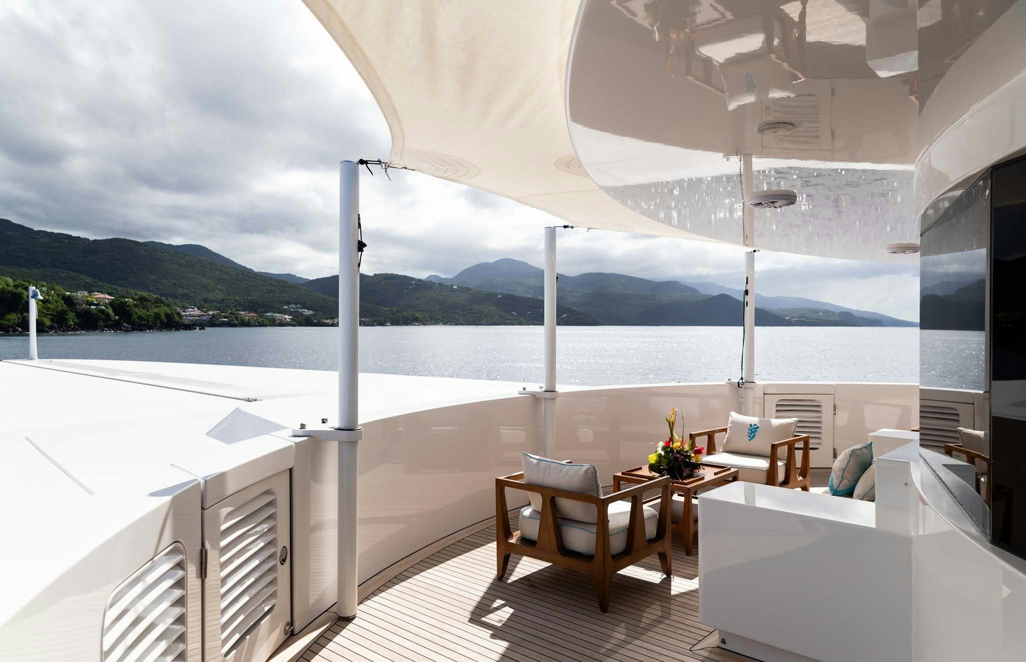 a large white balcony overlooking a body of water aboard AXIOMA Yacht for Charter