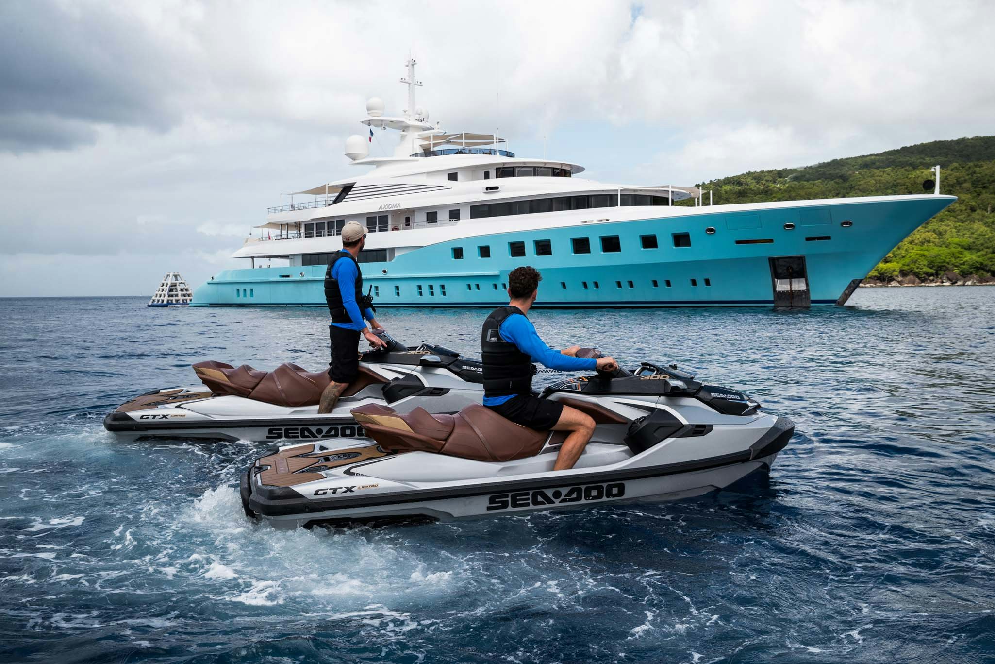 a couple of men on a boat in the water aboard AXIOMA Yacht for Charter