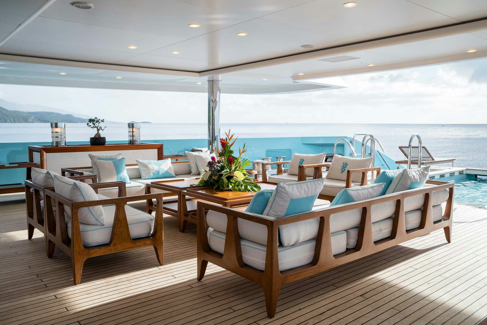 a room with chairs and tables aboard AXIOMA Yacht for Charter