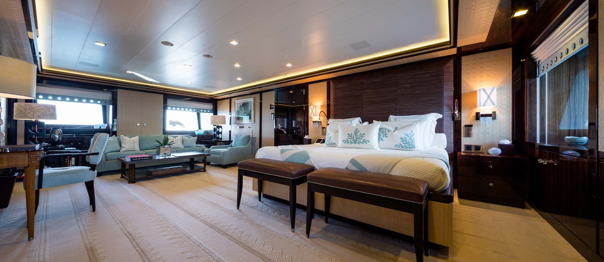 a room with a bed and a table aboard AXIOMA Yacht for Charter
