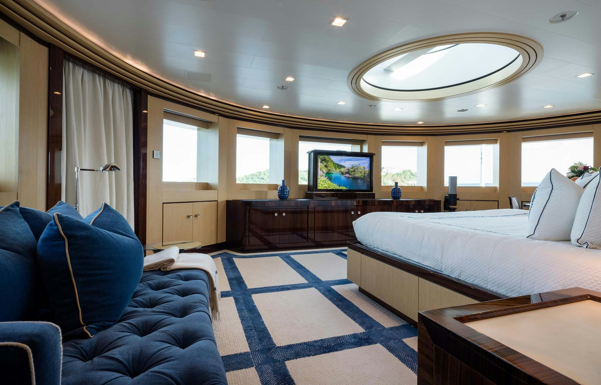 a room with a bed and a couch aboard AXIOMA Yacht for Charter