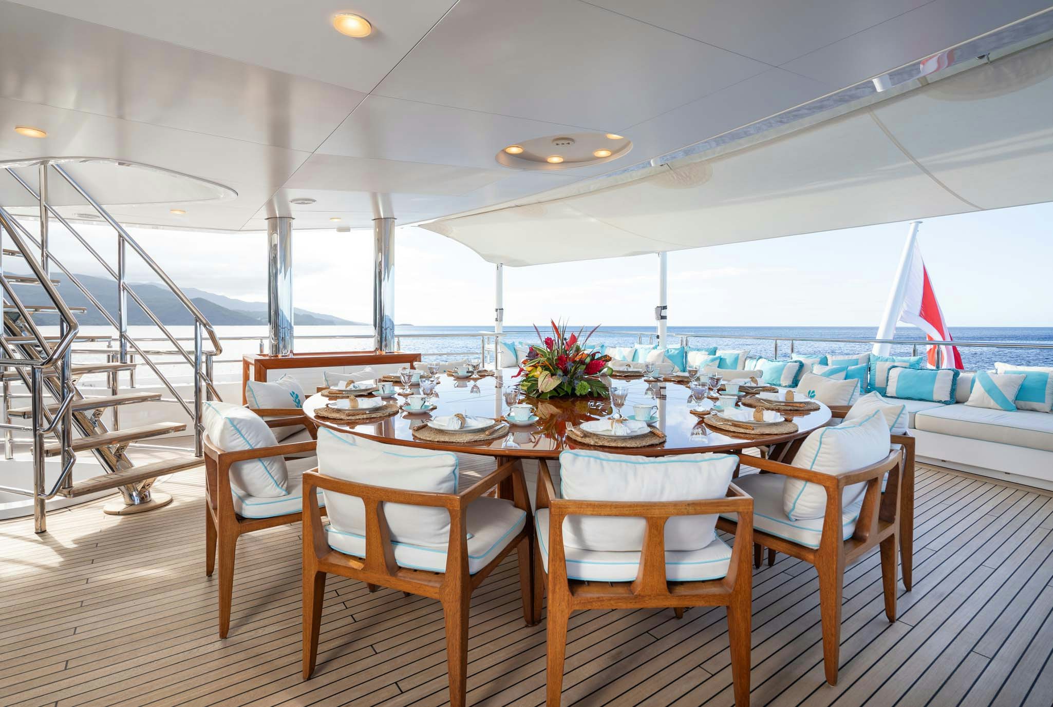 a room with tables and chairs aboard AXIOMA Yacht for Charter