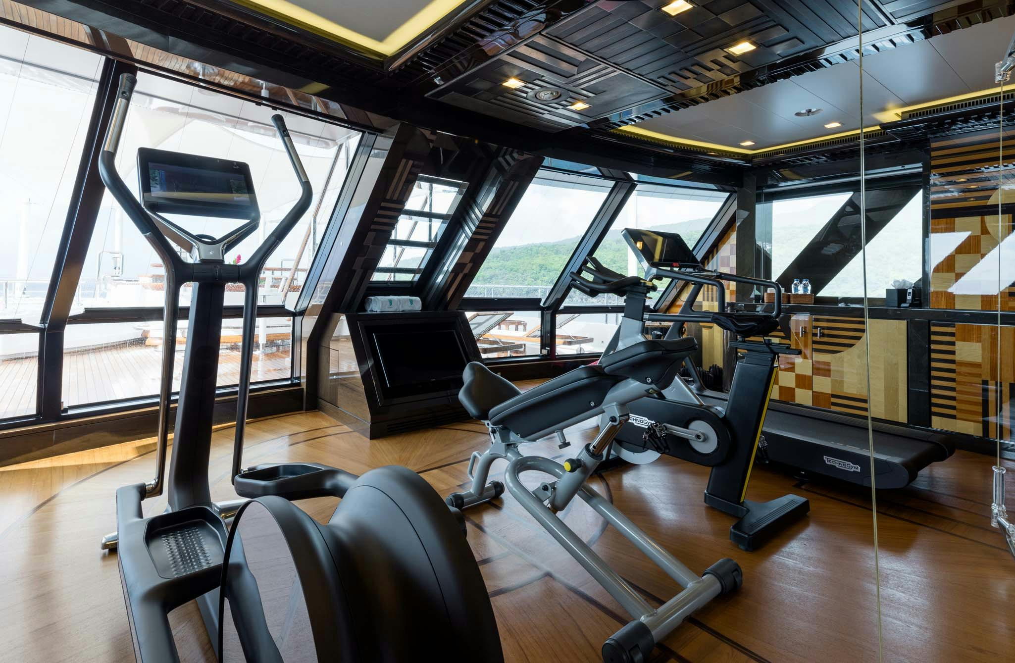 gym with large windows aboard AXIOMA Yacht for Charter