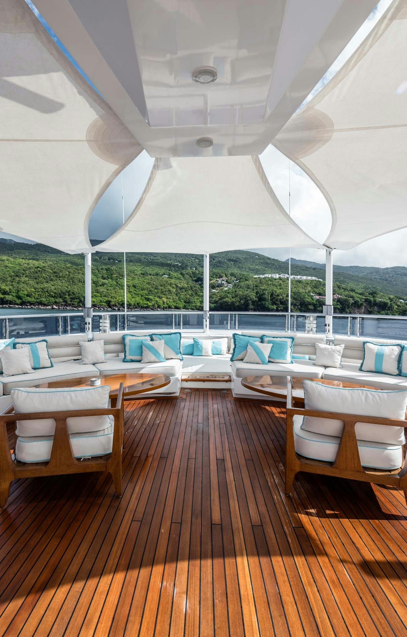 a room with tables and chairs aboard AXIOMA Yacht for Charter
