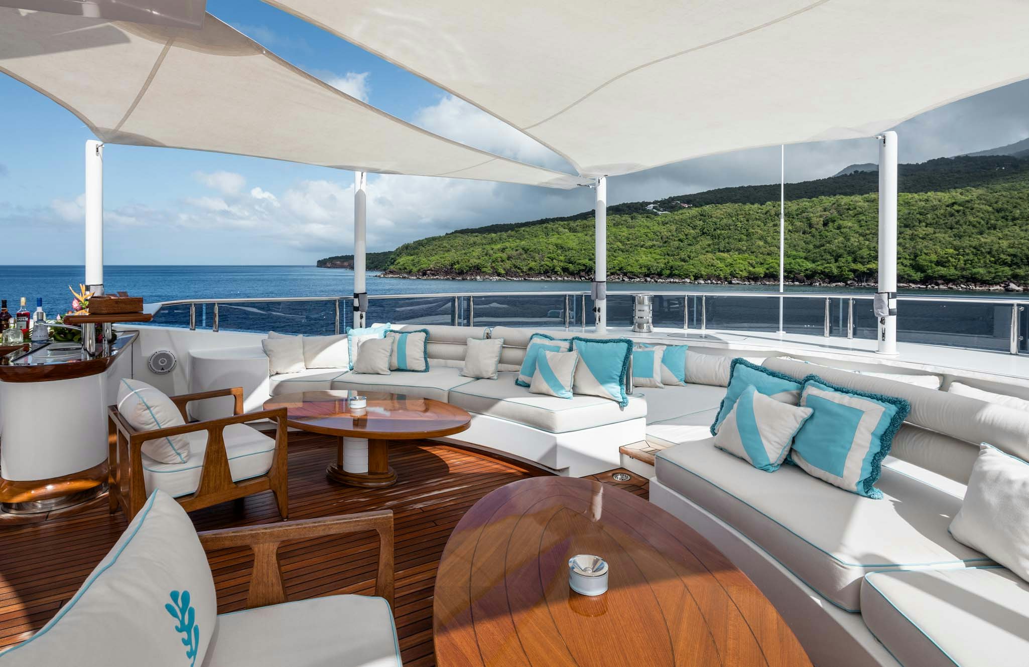 a large patio with a table and chairs and a large body of water aboard AXIOMA Yacht for Charter
