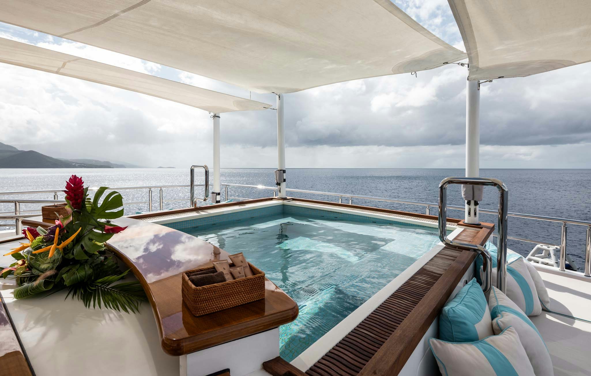 a boat with a picnic table and towels on the deck aboard AXIOMA Yacht for Charter