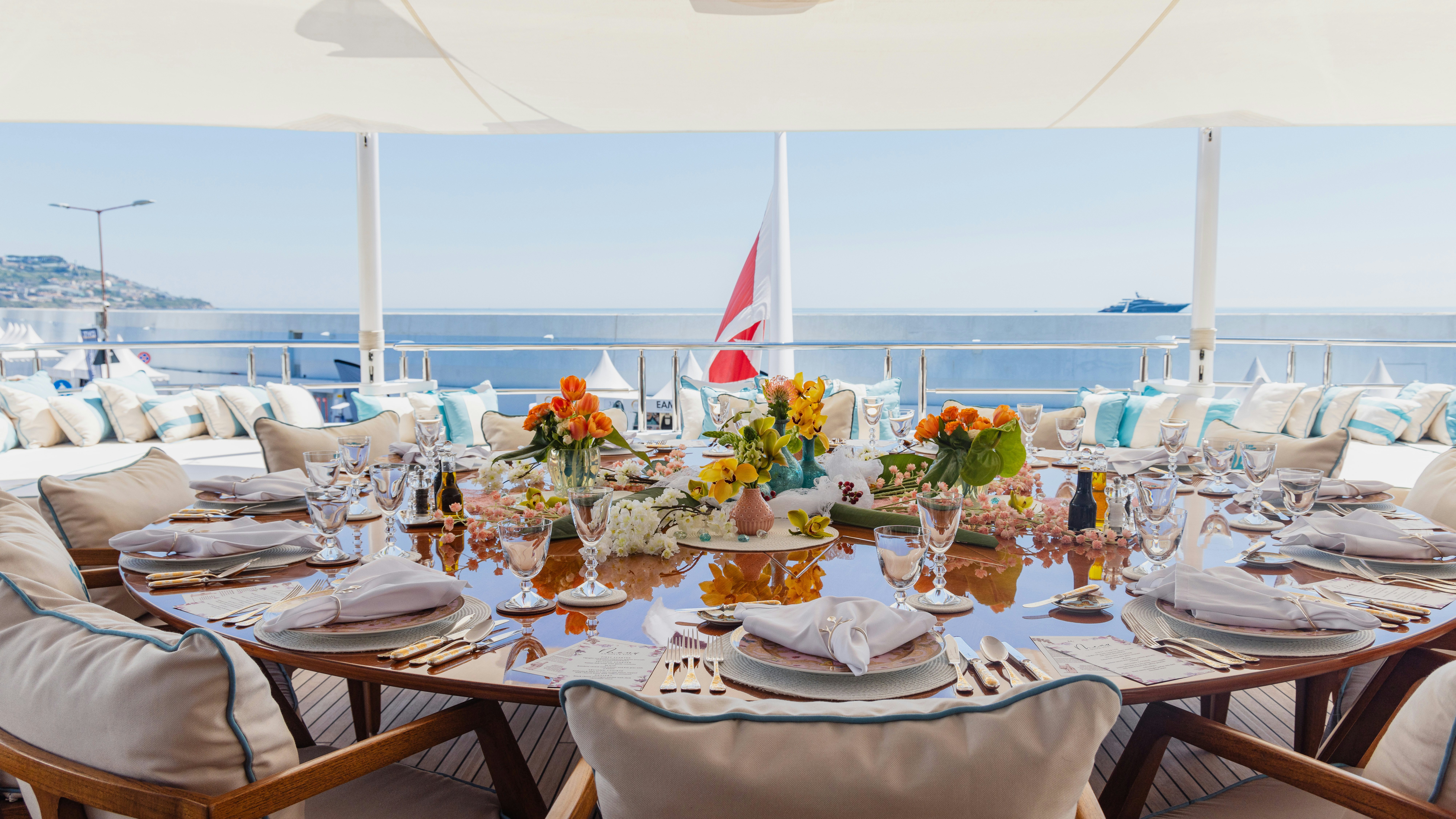 a table set for a dinner aboard AXIOMA Yacht for Charter