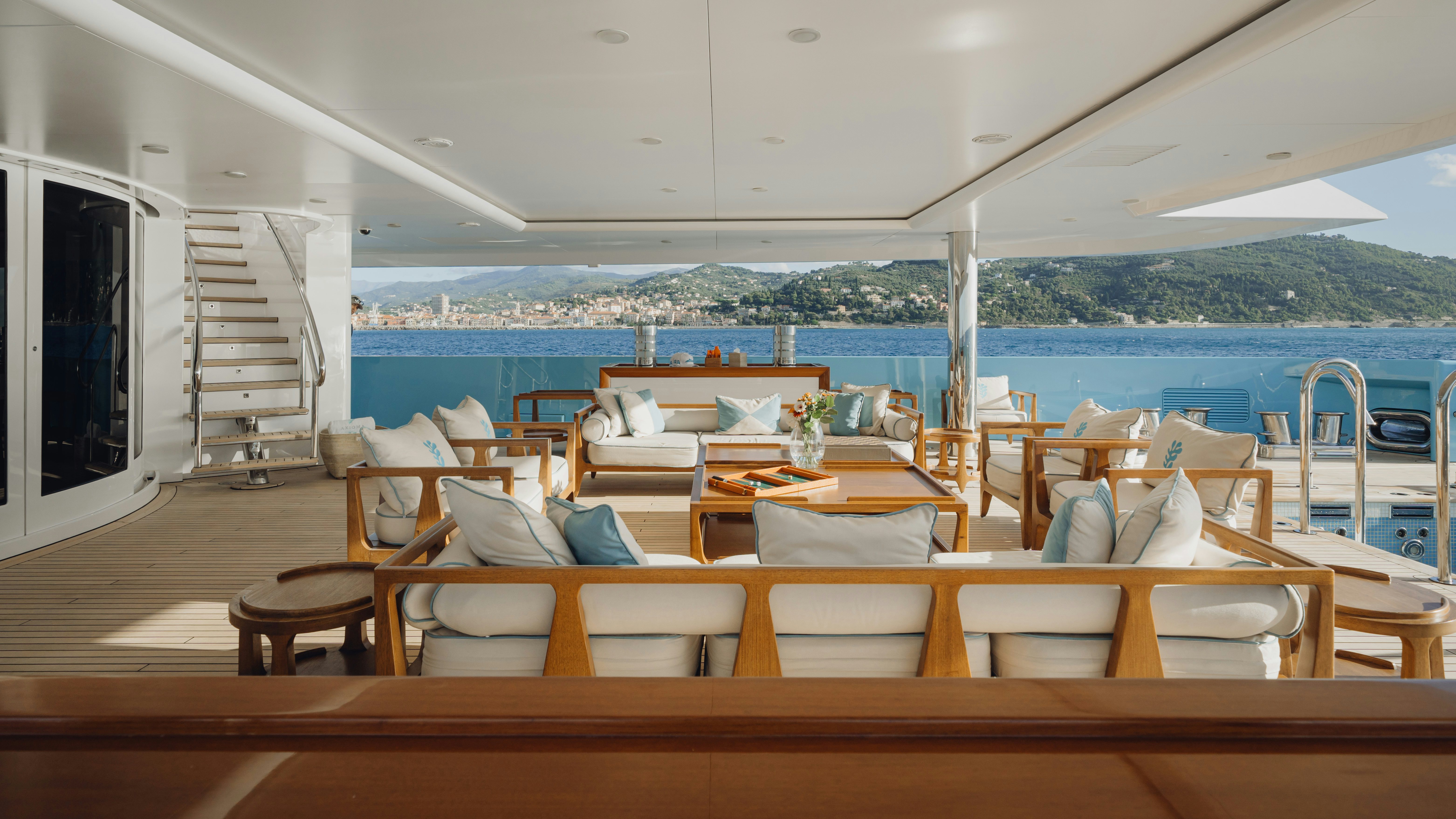a room with a view of the ocean and a balcony aboard AXIOMA Yacht for Sale