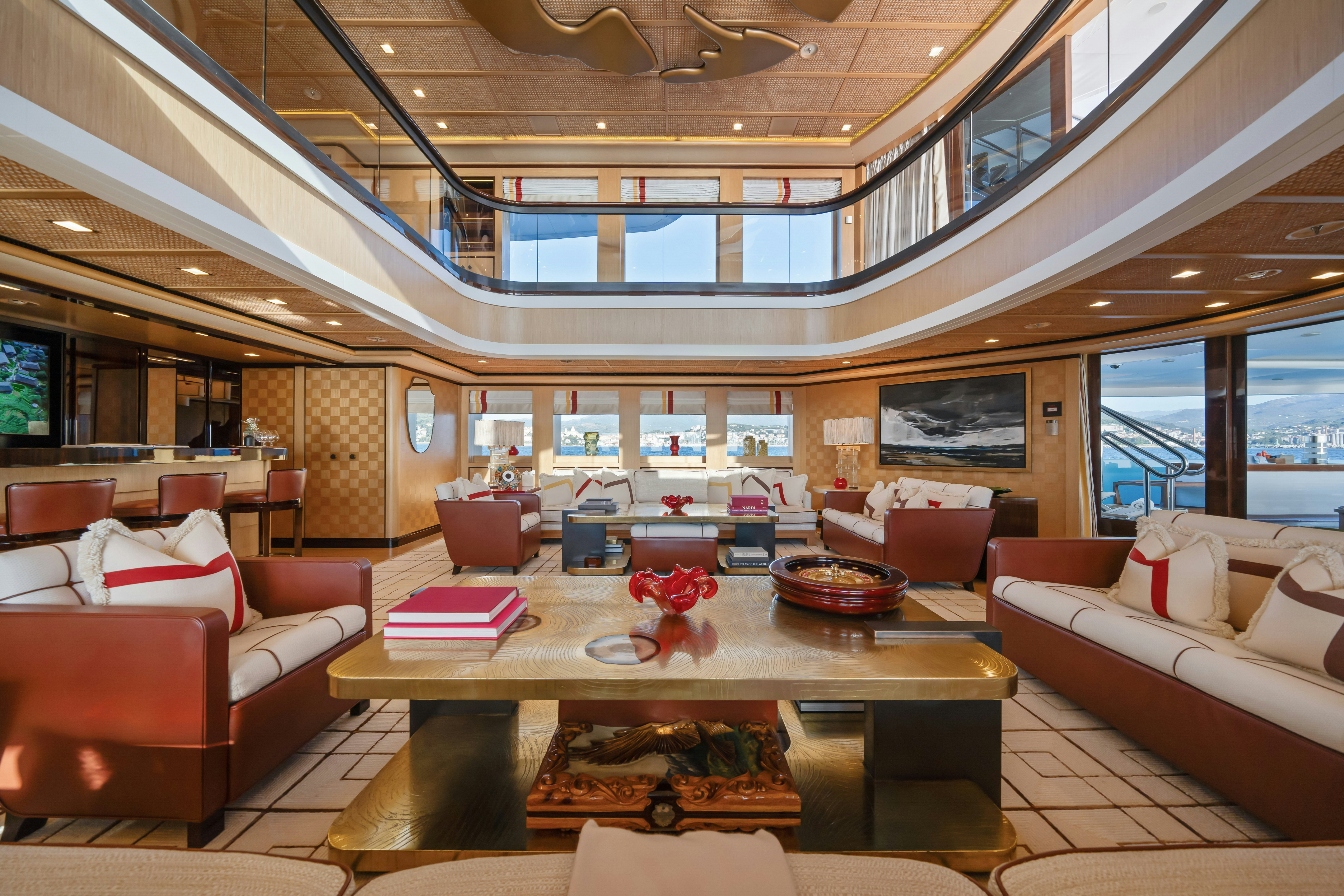 a living room with a table and couches aboard AXIOMA Yacht for Sale
