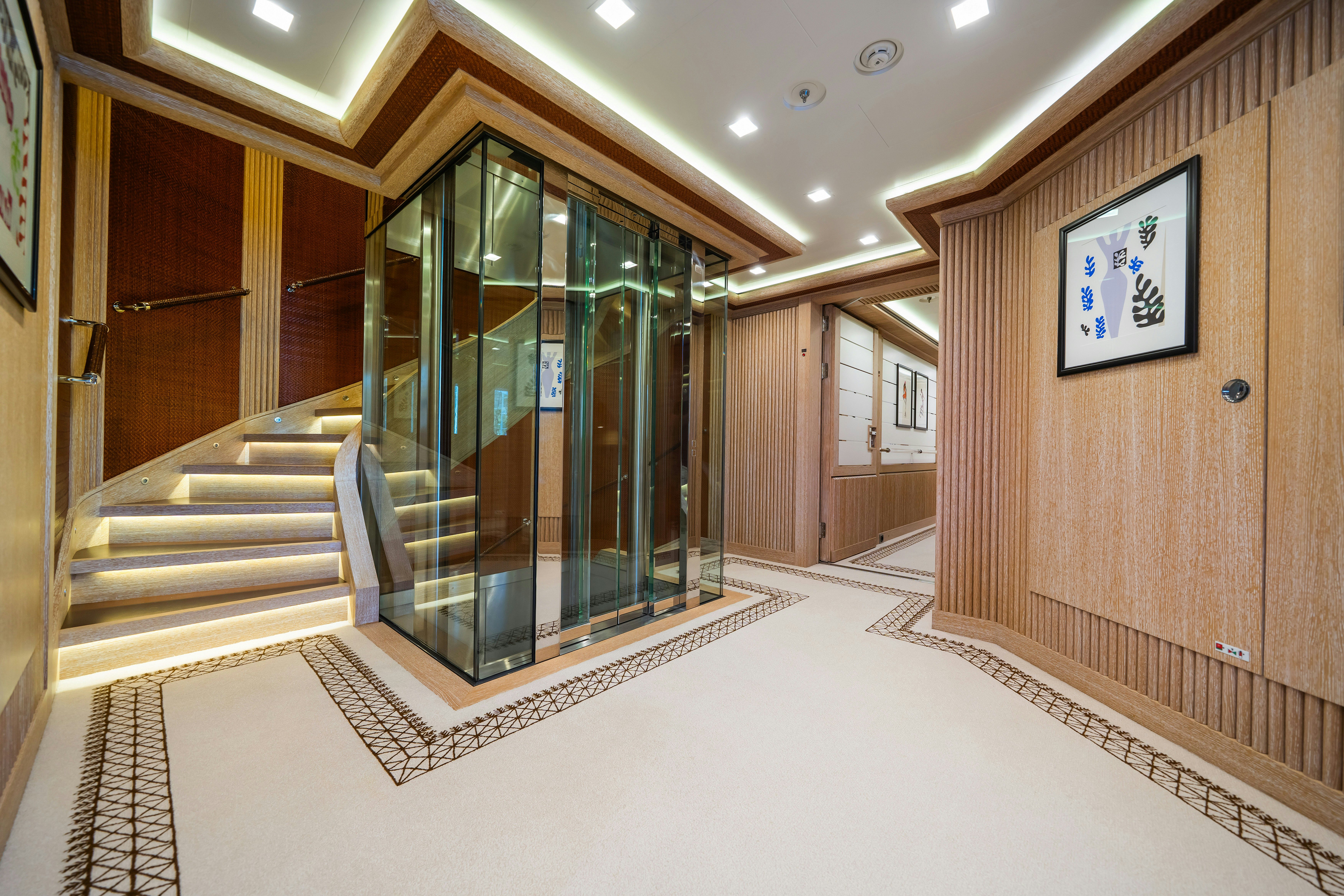 a hallway with glass doors aboard AXIOMA Yacht for Sale