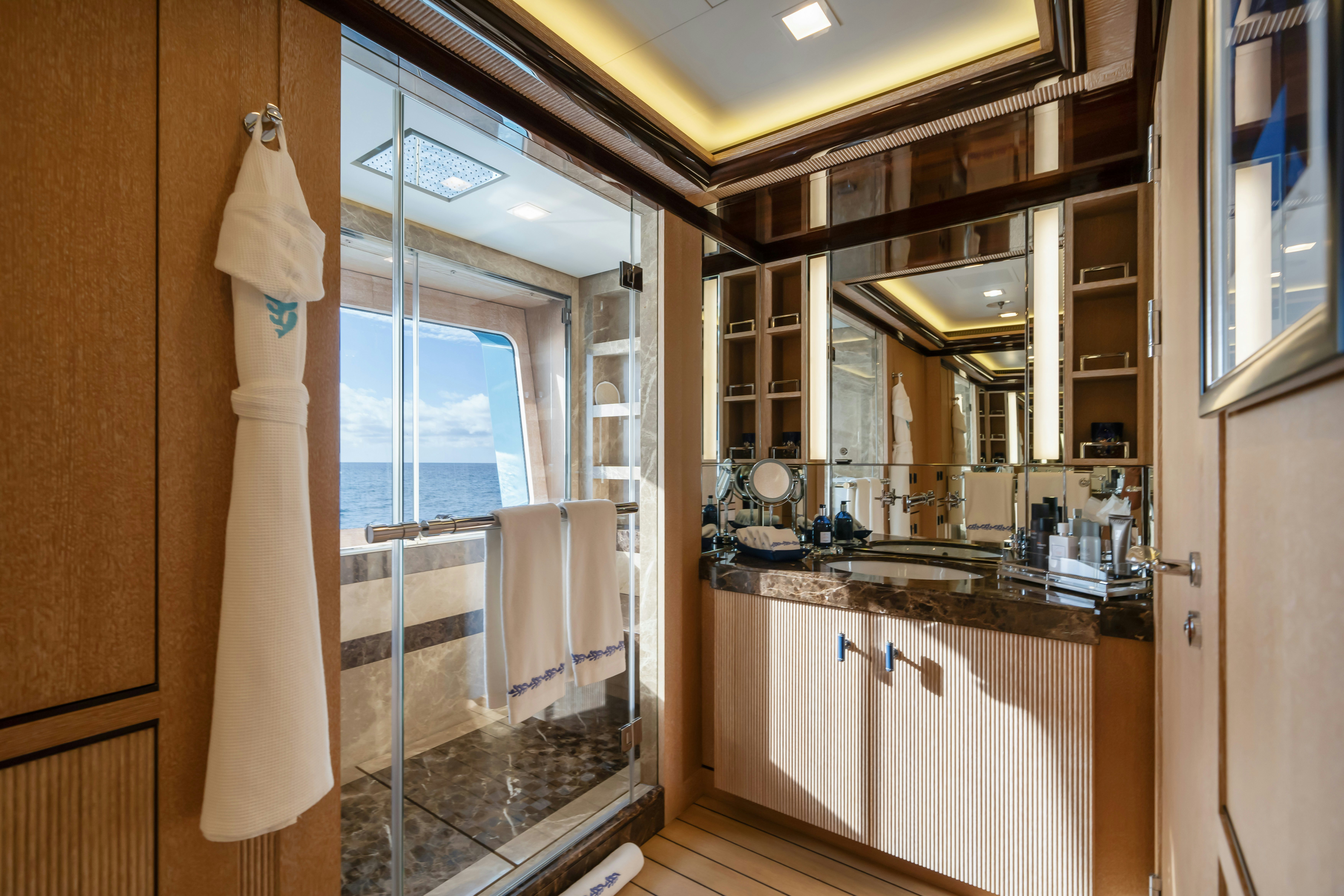 a bathroom with a glass shower aboard AXIOMA Yacht for Sale
