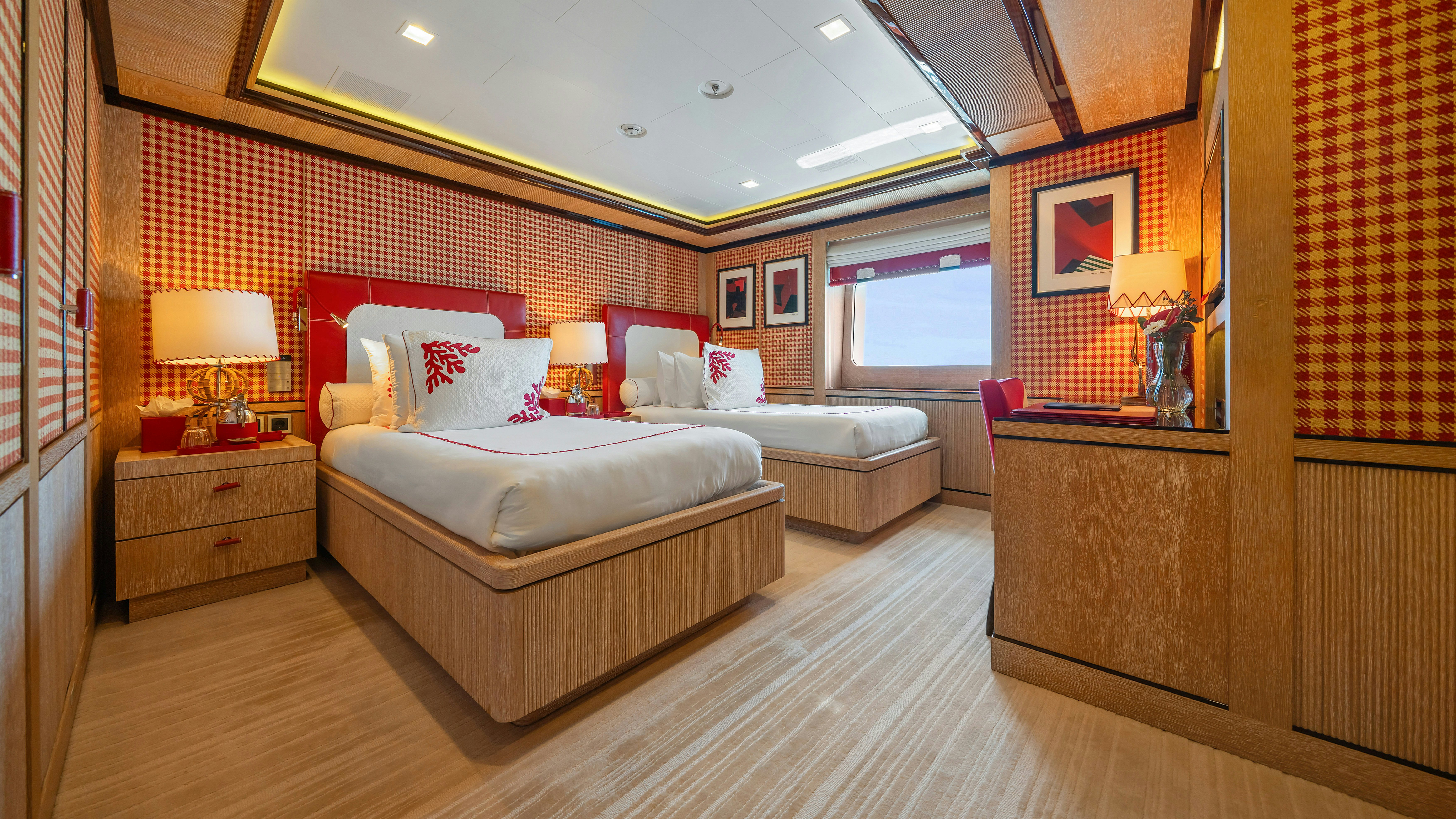 a room with a bed and a desk aboard AXIOMA Yacht for Sale