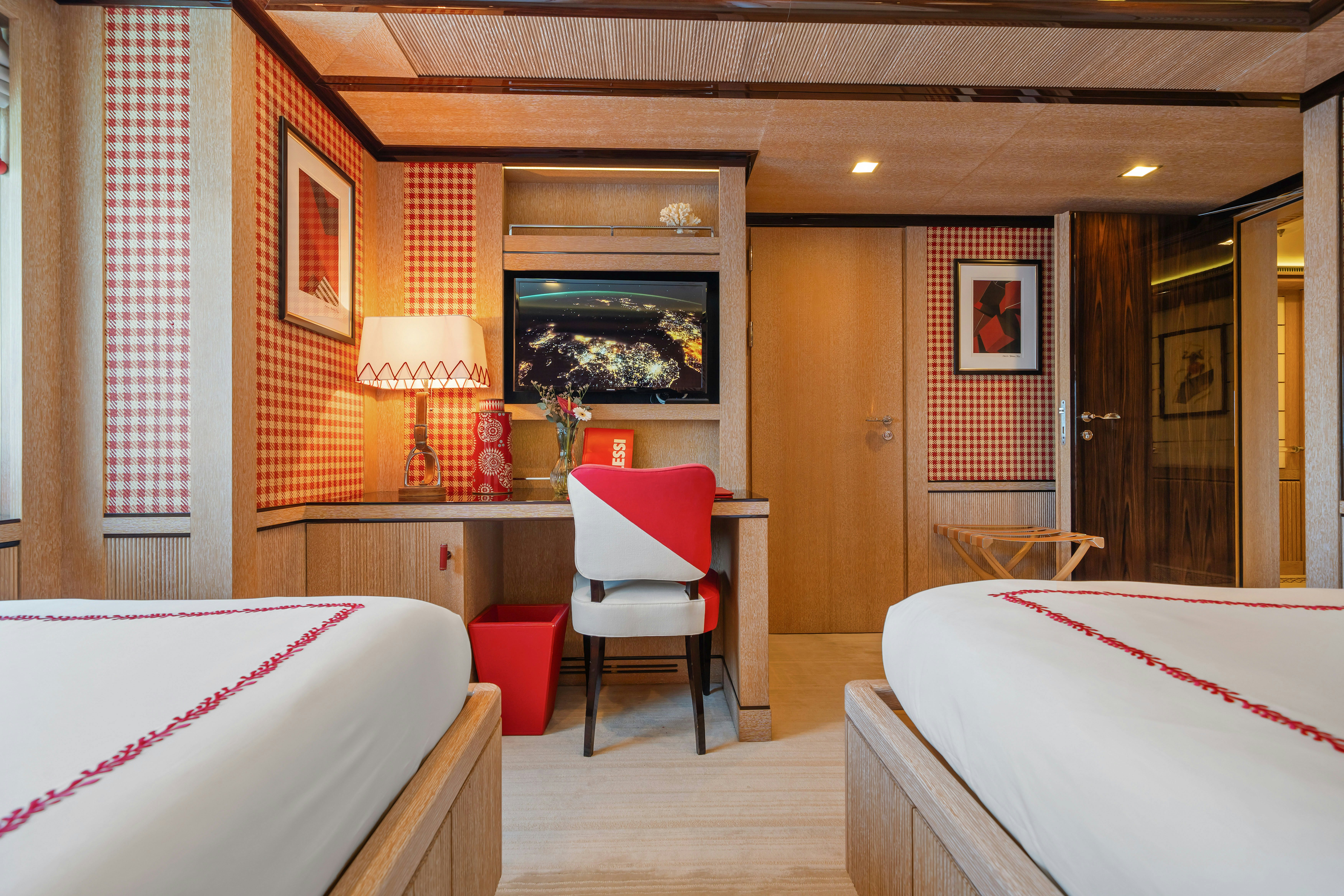 a room with a bed and a chair aboard AXIOMA Yacht for Sale