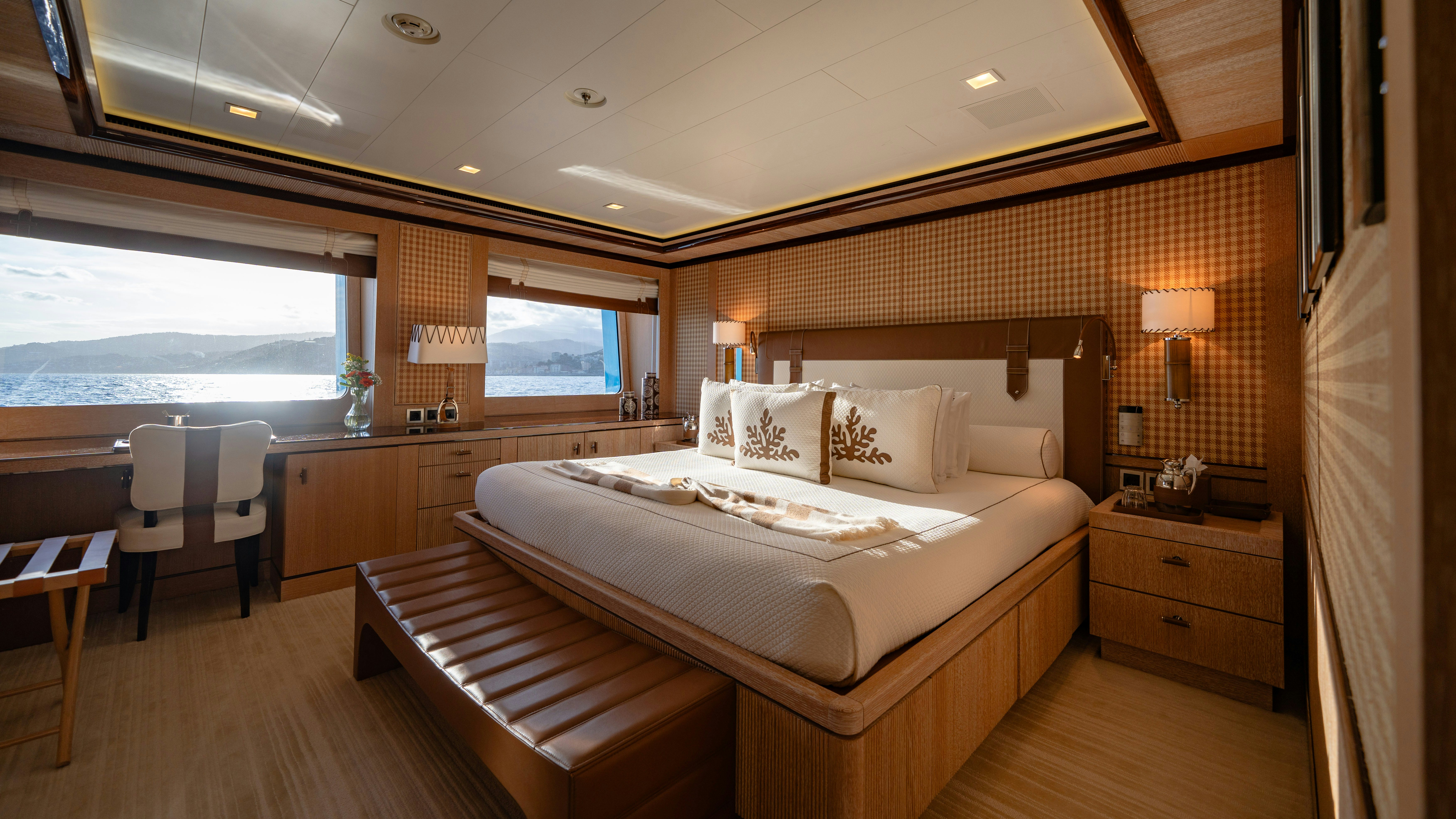 a room with a bed and a table aboard AXIOMA Yacht for Sale