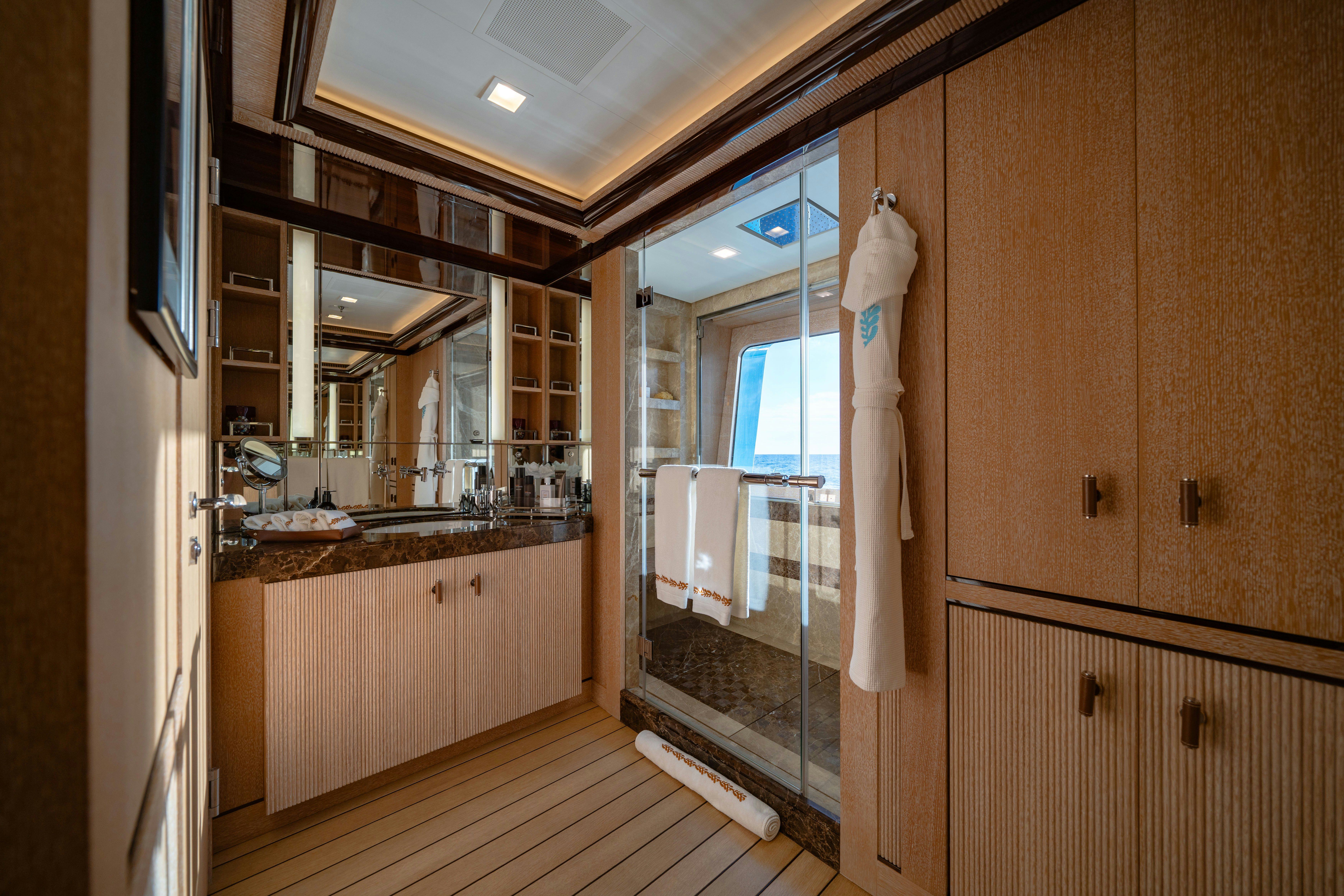 a bathroom with wooden cabinets aboard AXIOMA Yacht for Sale