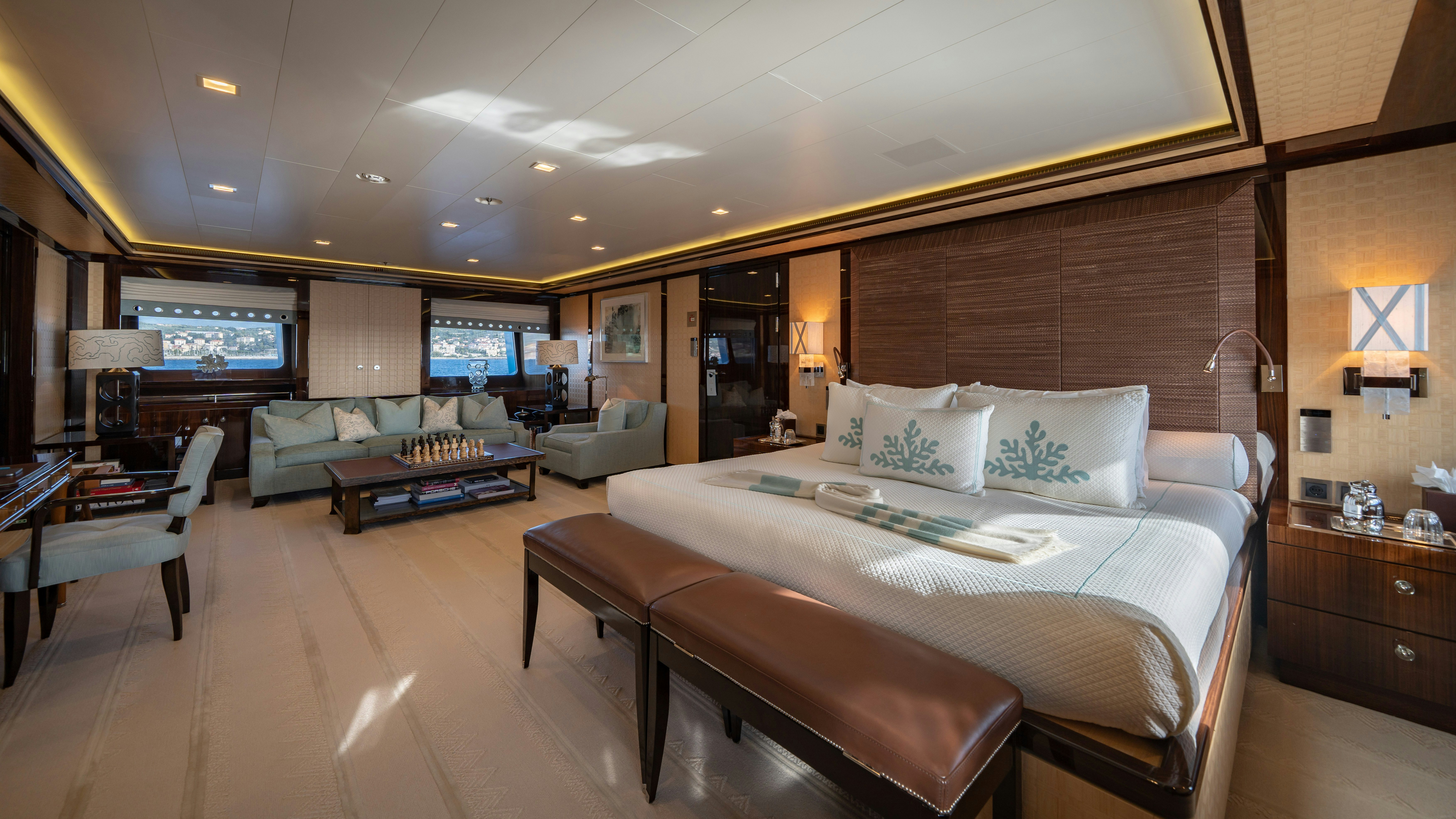 a large room with a bed and a couch aboard AXIOMA Yacht for Sale