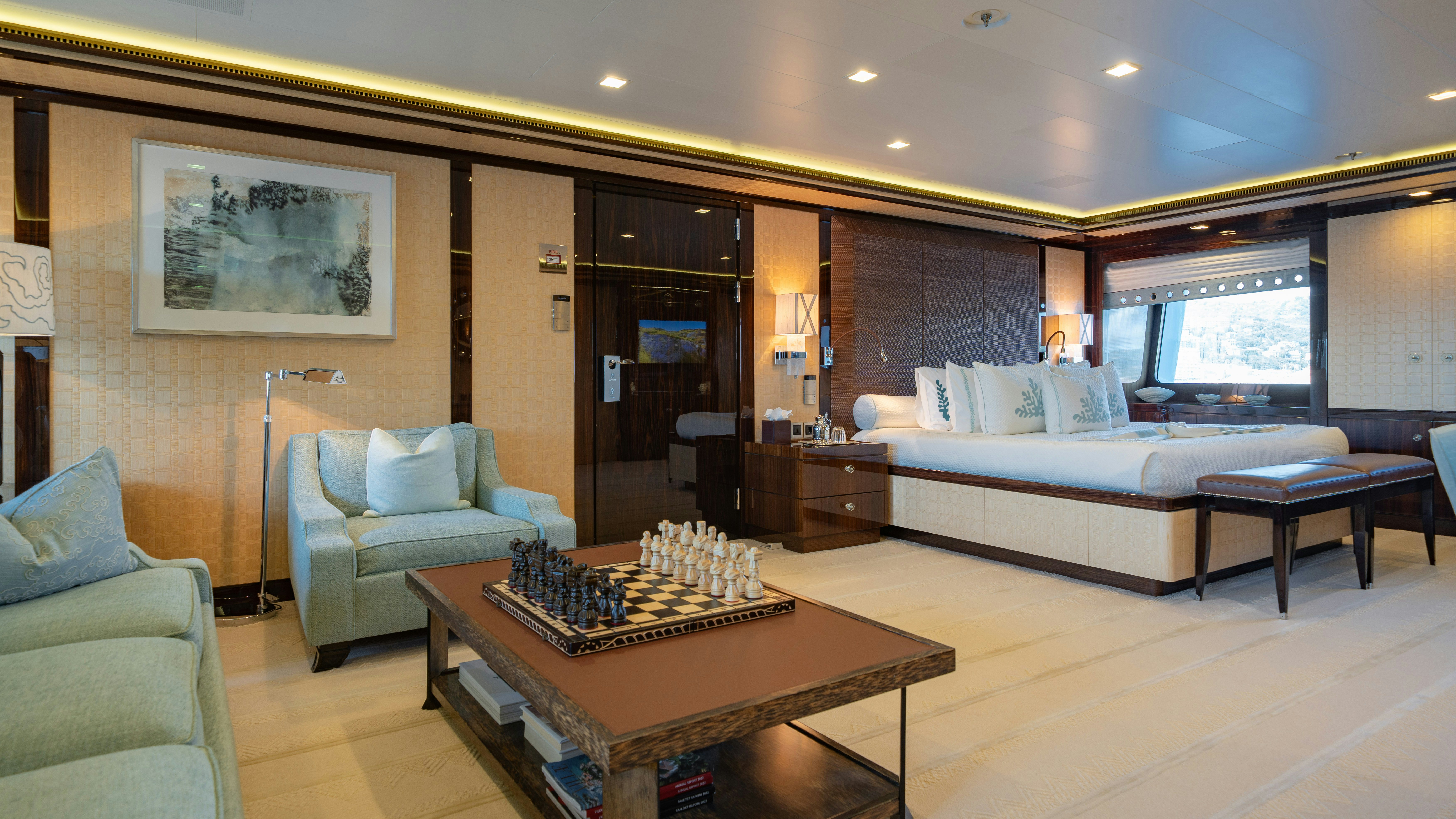 a large living room with a large white couch and a coffee table aboard AXIOMA Yacht for Sale