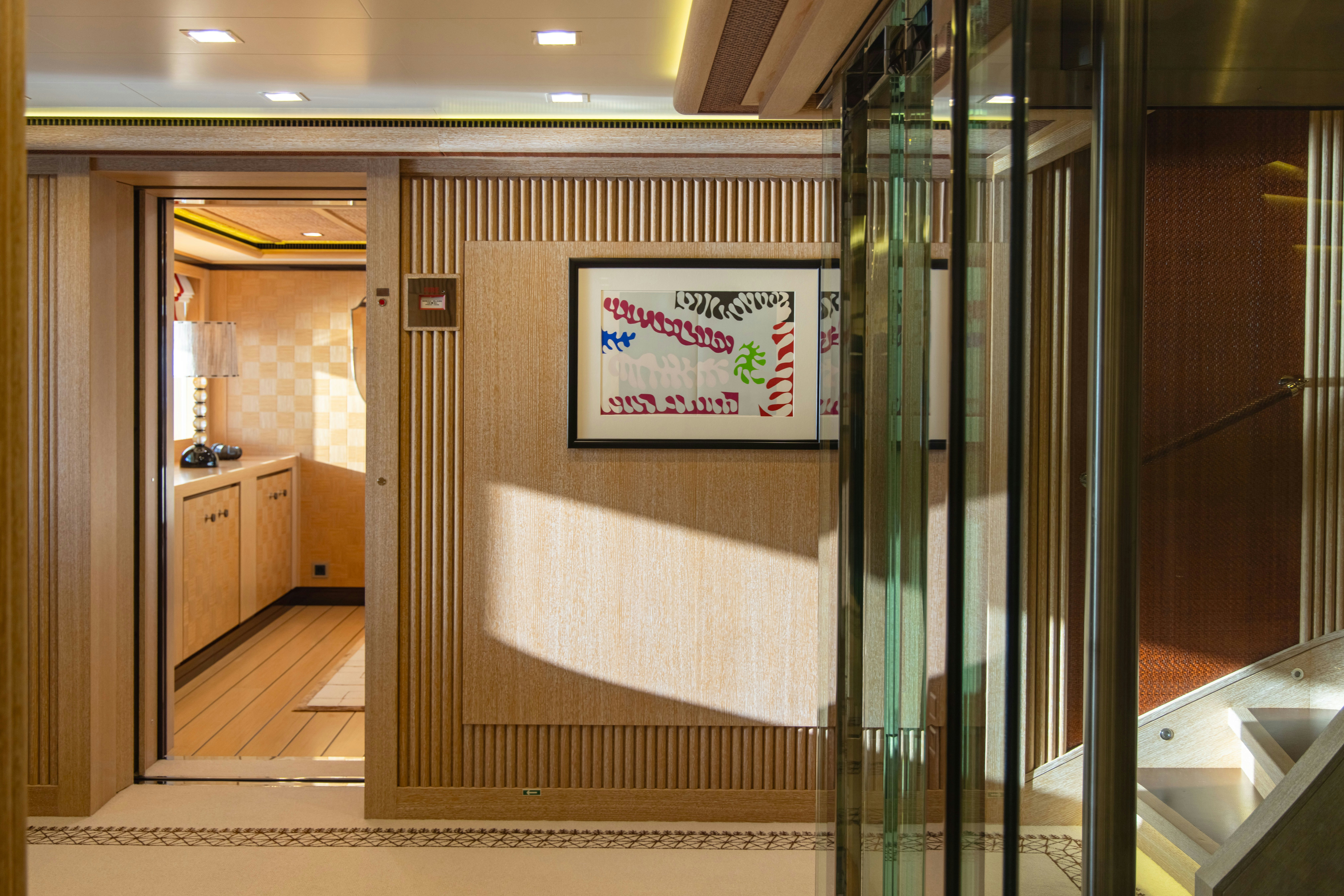 a hallway with glass doors aboard AXIOMA Yacht for Sale