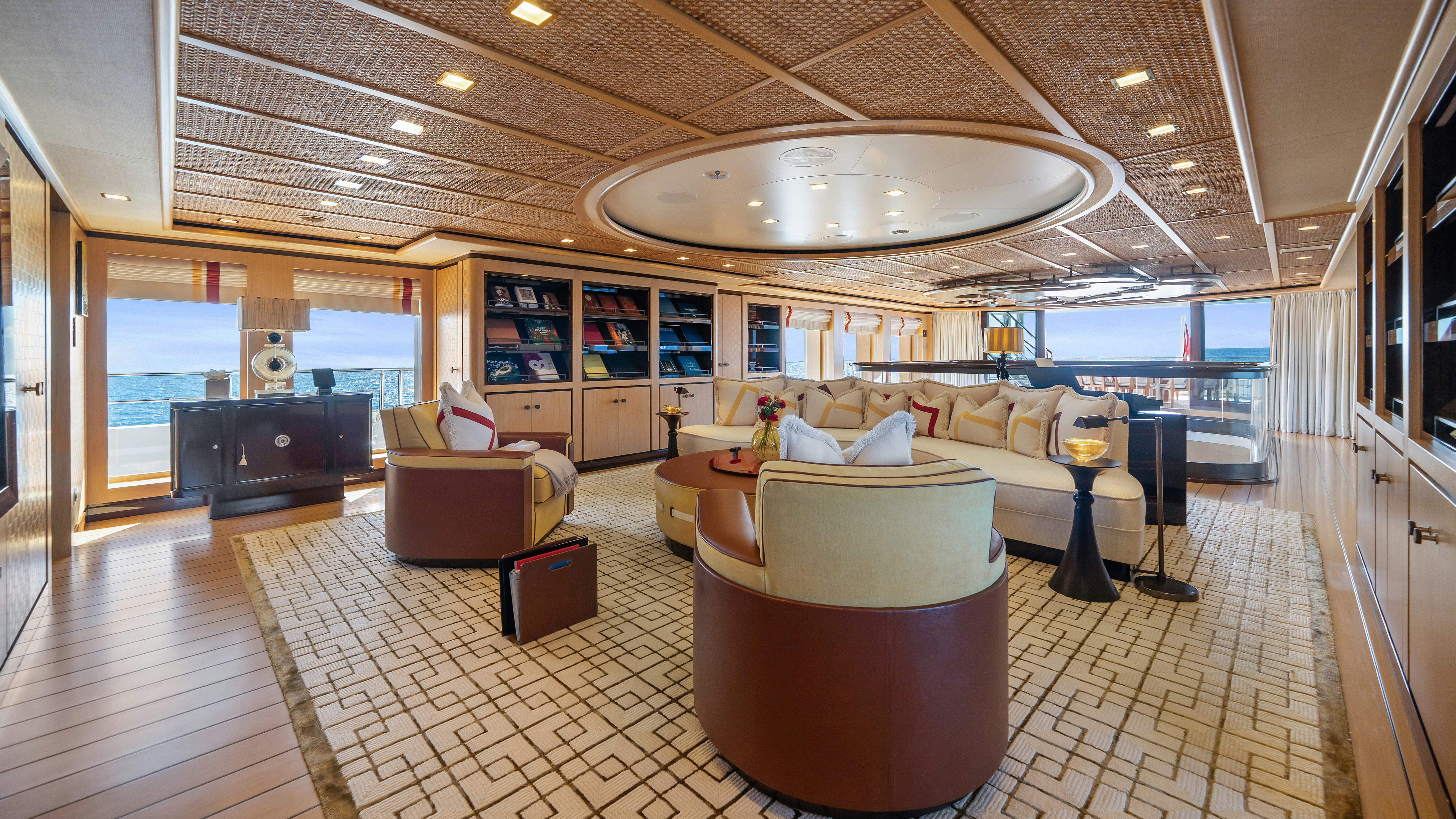 a large living room with a large chandelier aboard AXIOMA Yacht for Sale