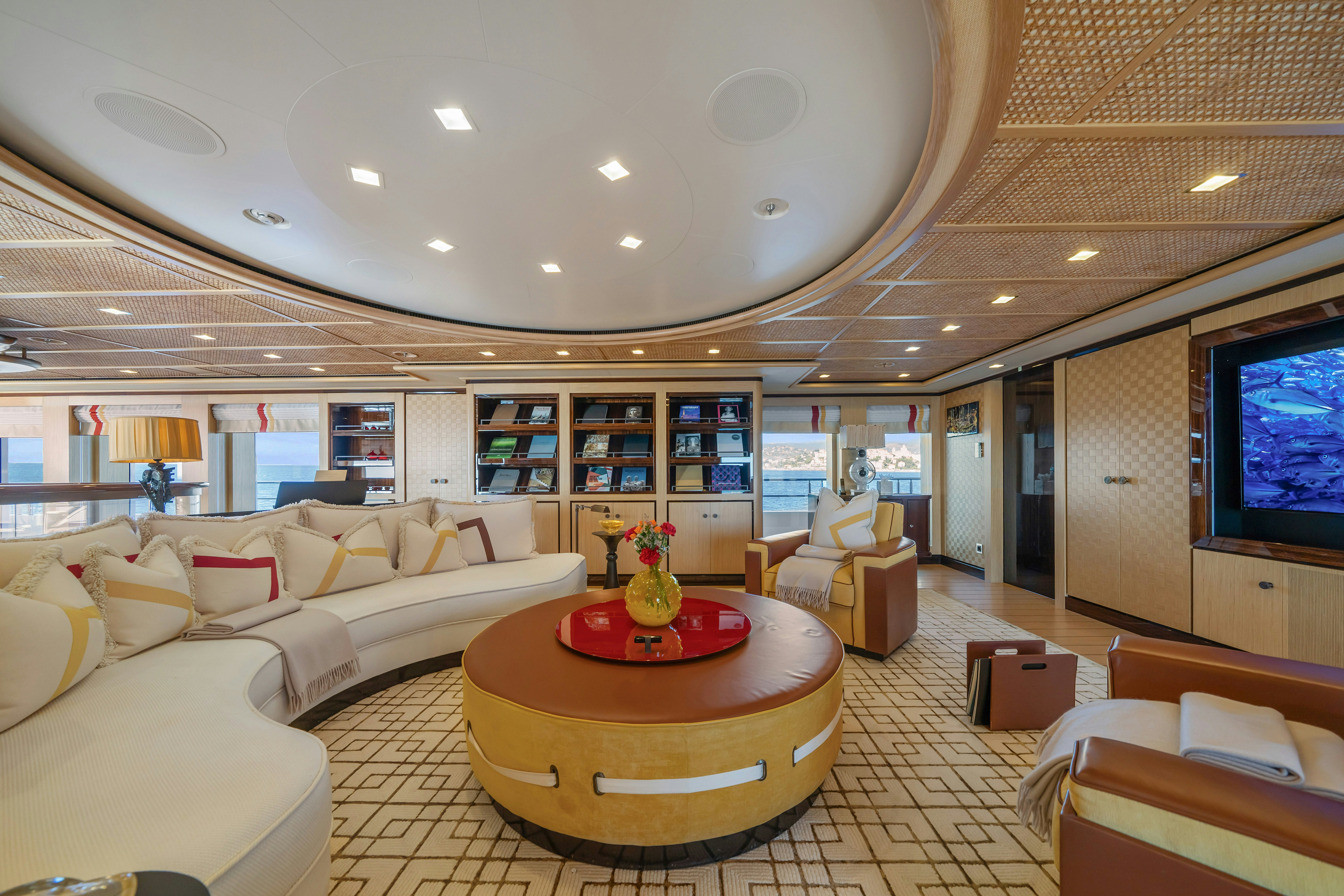 a living room with a large table and couches aboard AXIOMA Yacht for Sale