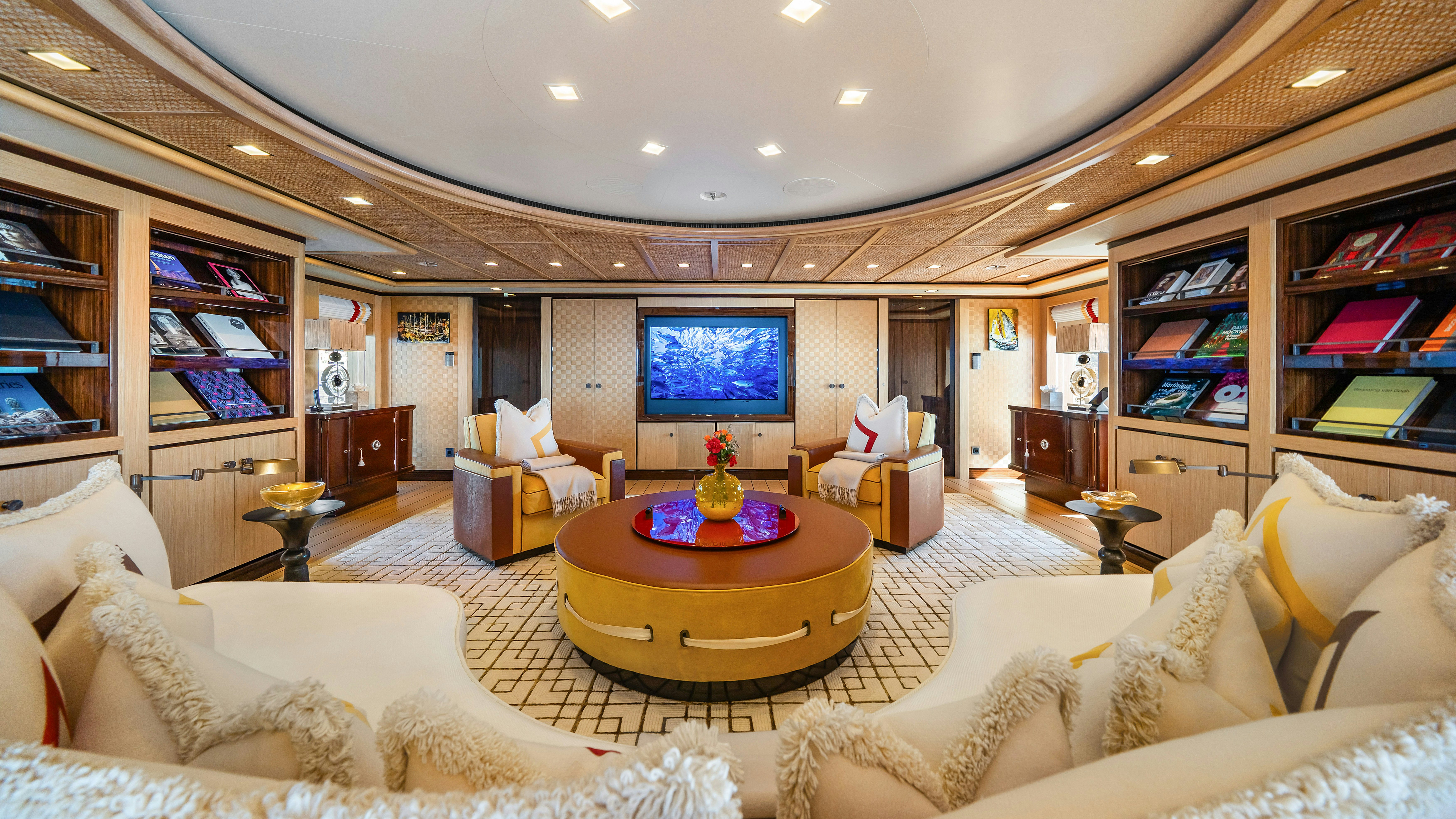a living room with a large screen aboard AXIOMA Yacht for Sale