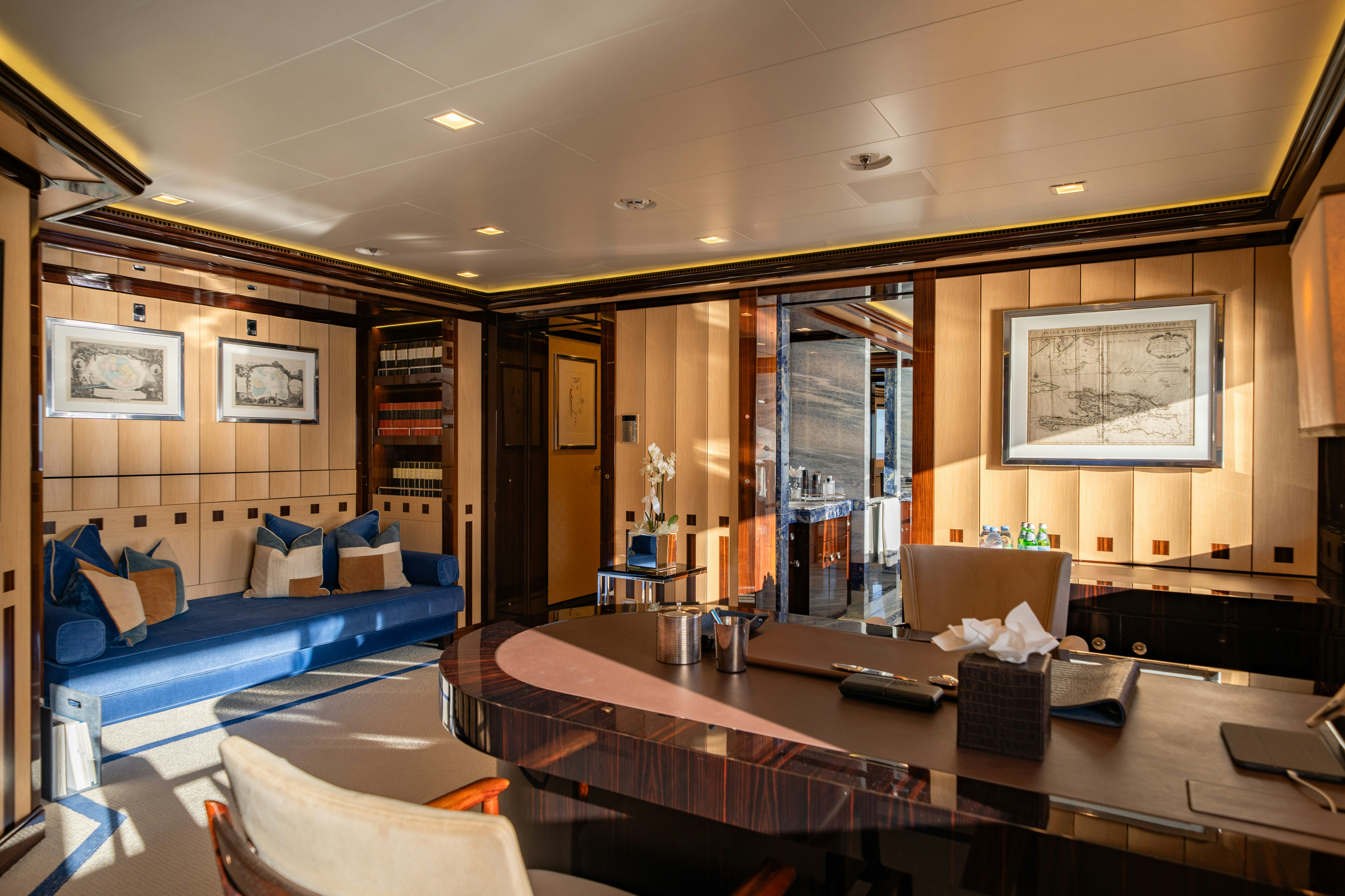 a large living room with a large table and couches aboard AXIOMA Yacht for Sale