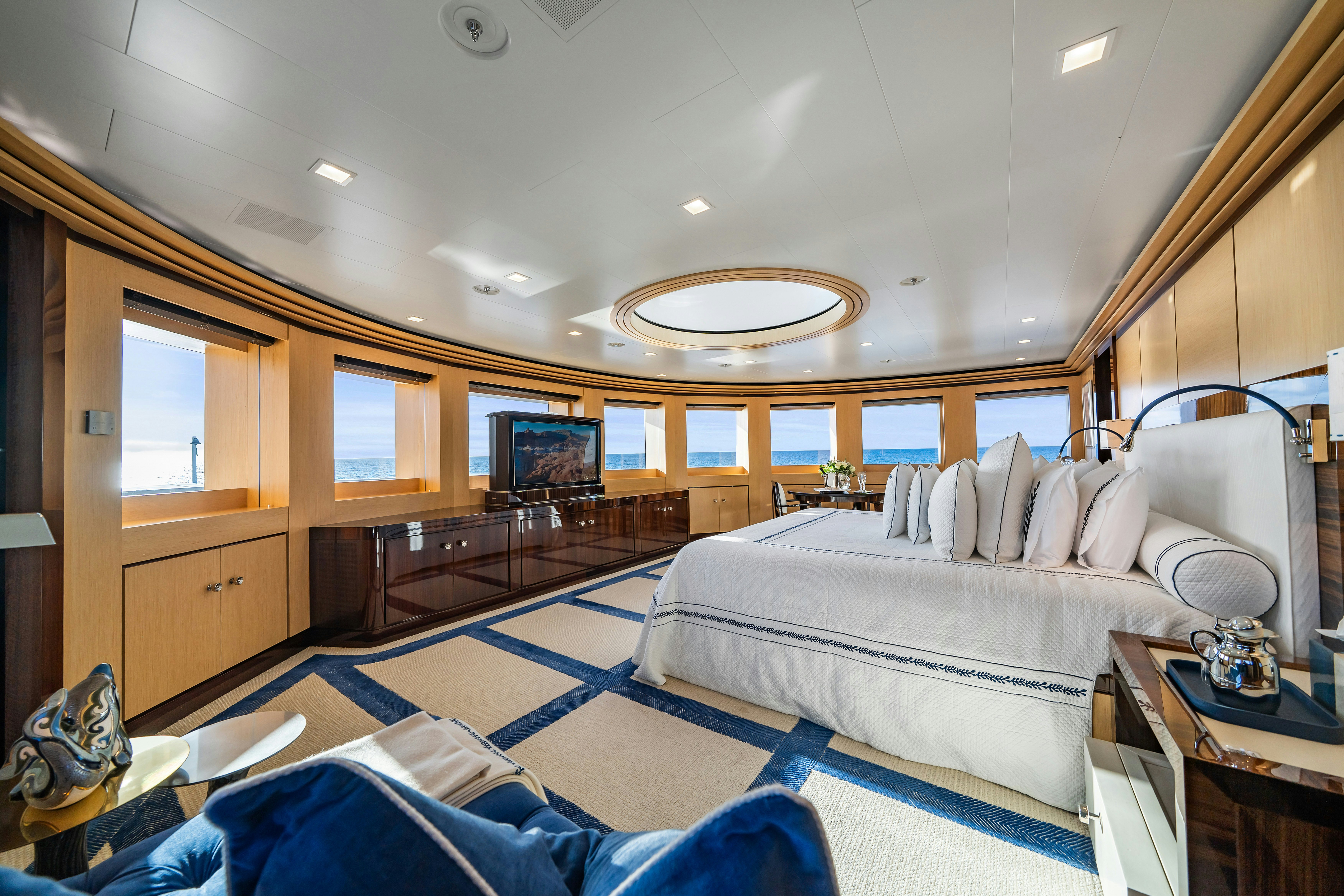 a bedroom with a bed and a large mirror aboard AXIOMA Yacht for Sale
