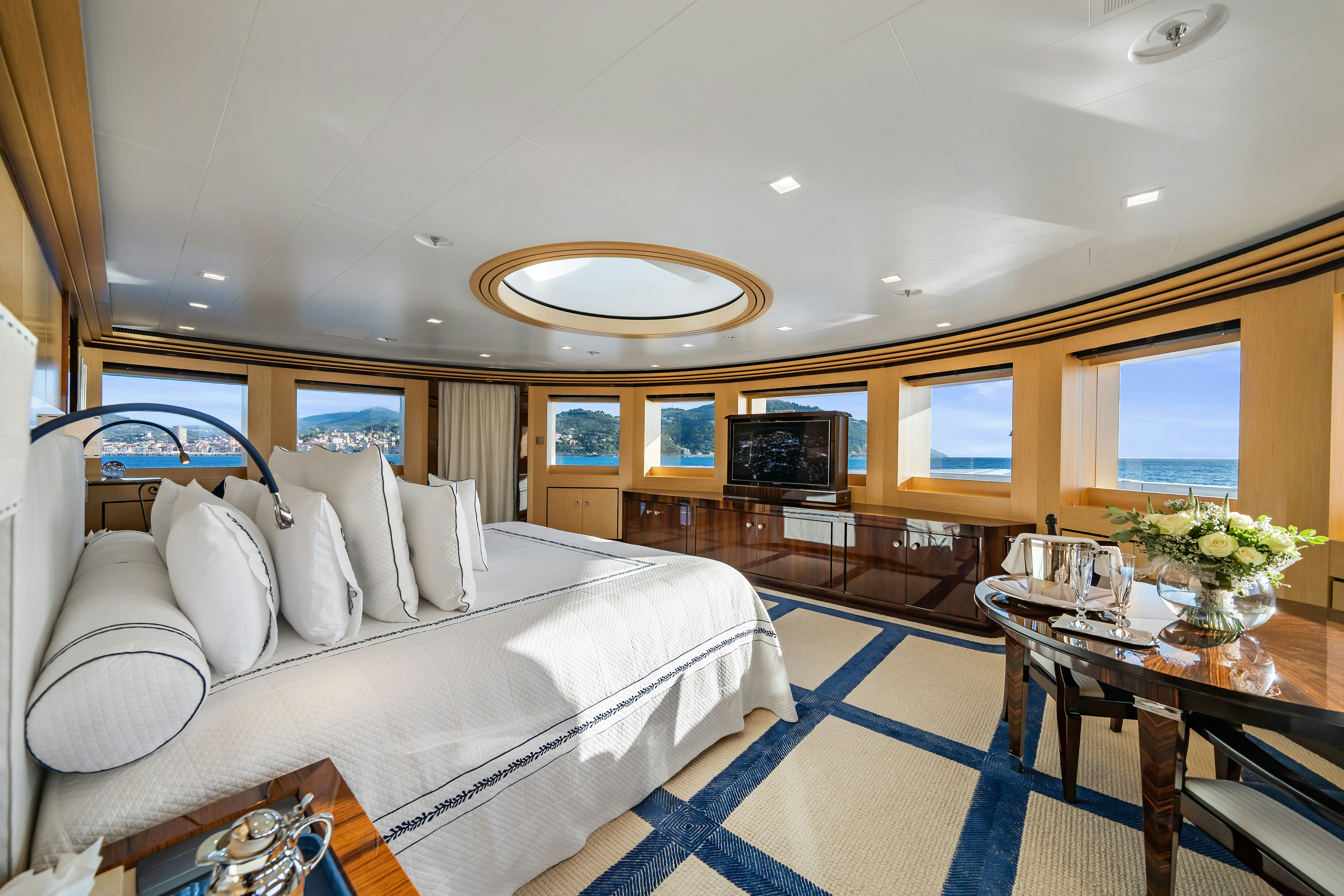 a bedroom with a bed and a table aboard AXIOMA Yacht for Sale