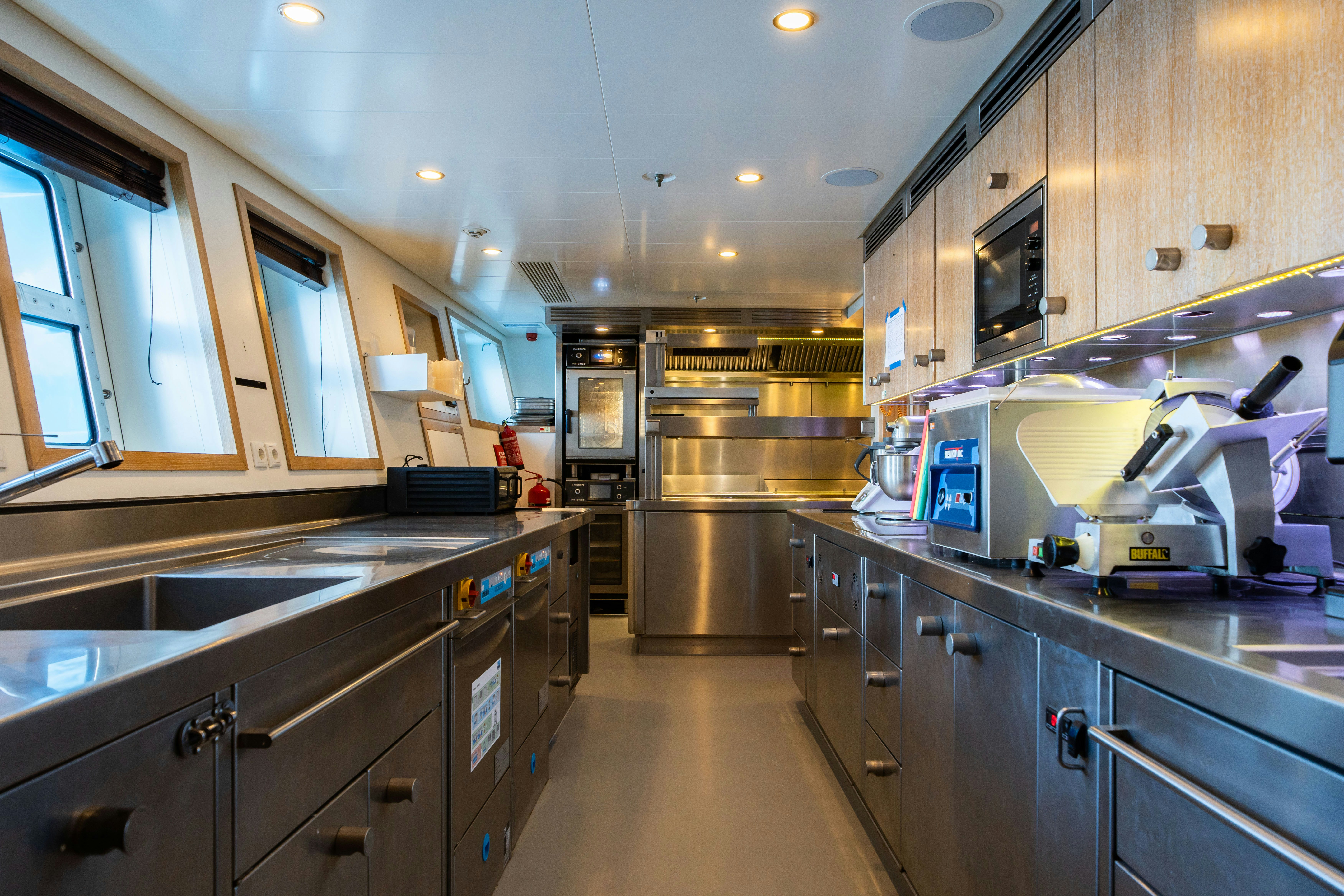 a kitchen with stainless steel appliances aboard AXIOMA Yacht for Sale
