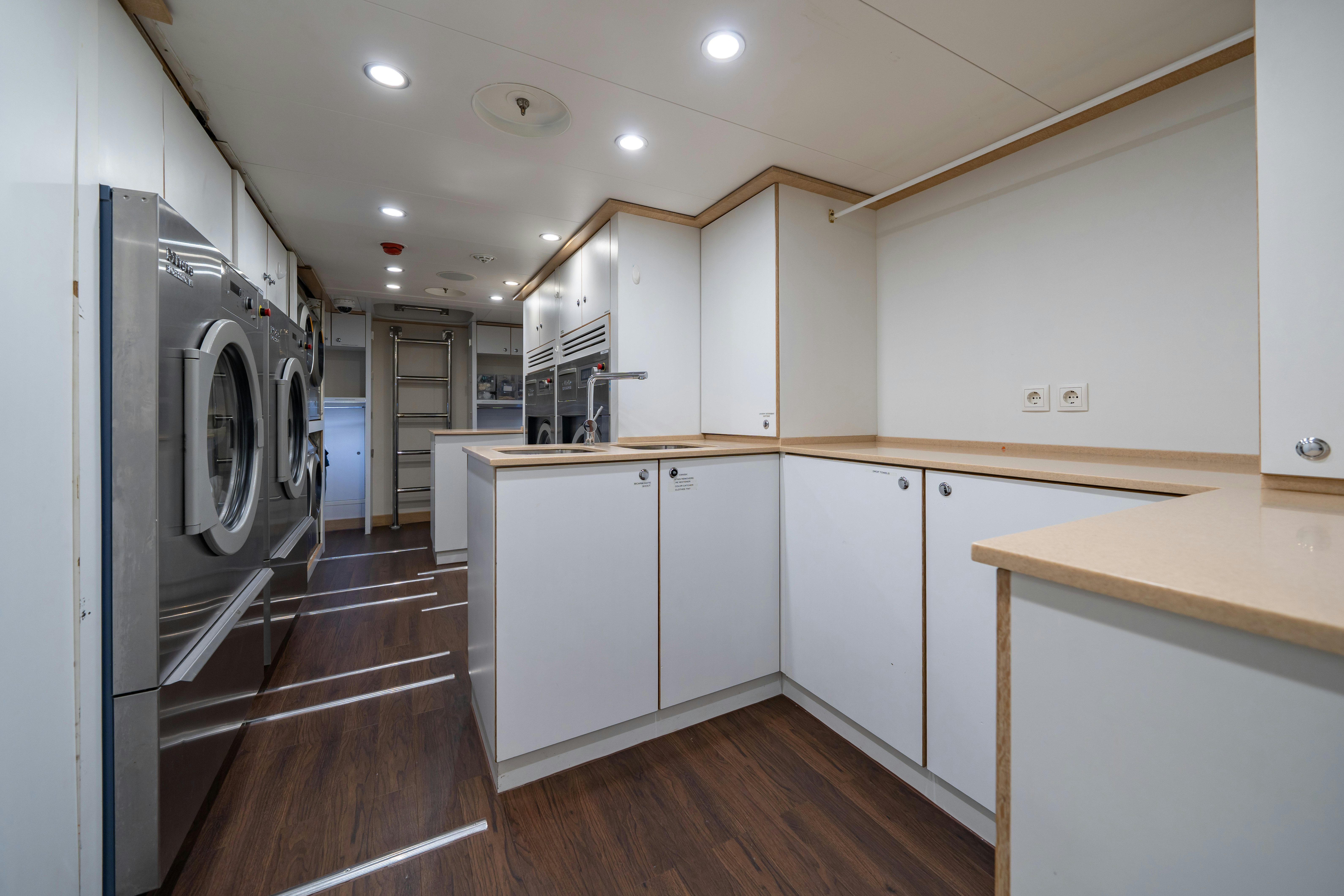 a kitchen with white cabinets aboard AXIOMA Yacht for Sale