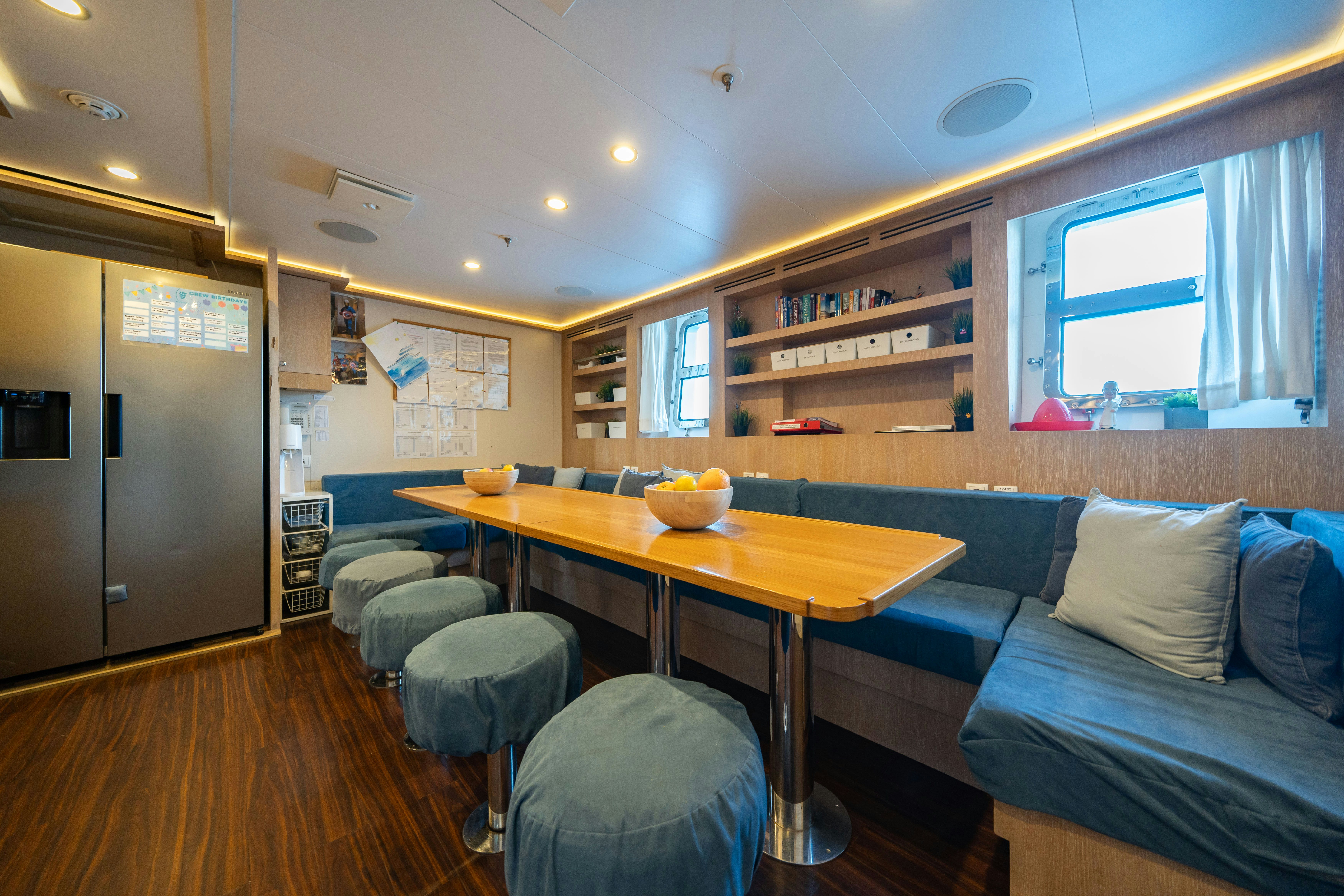 a living room with a couch and a table aboard AXIOMA Yacht for Sale