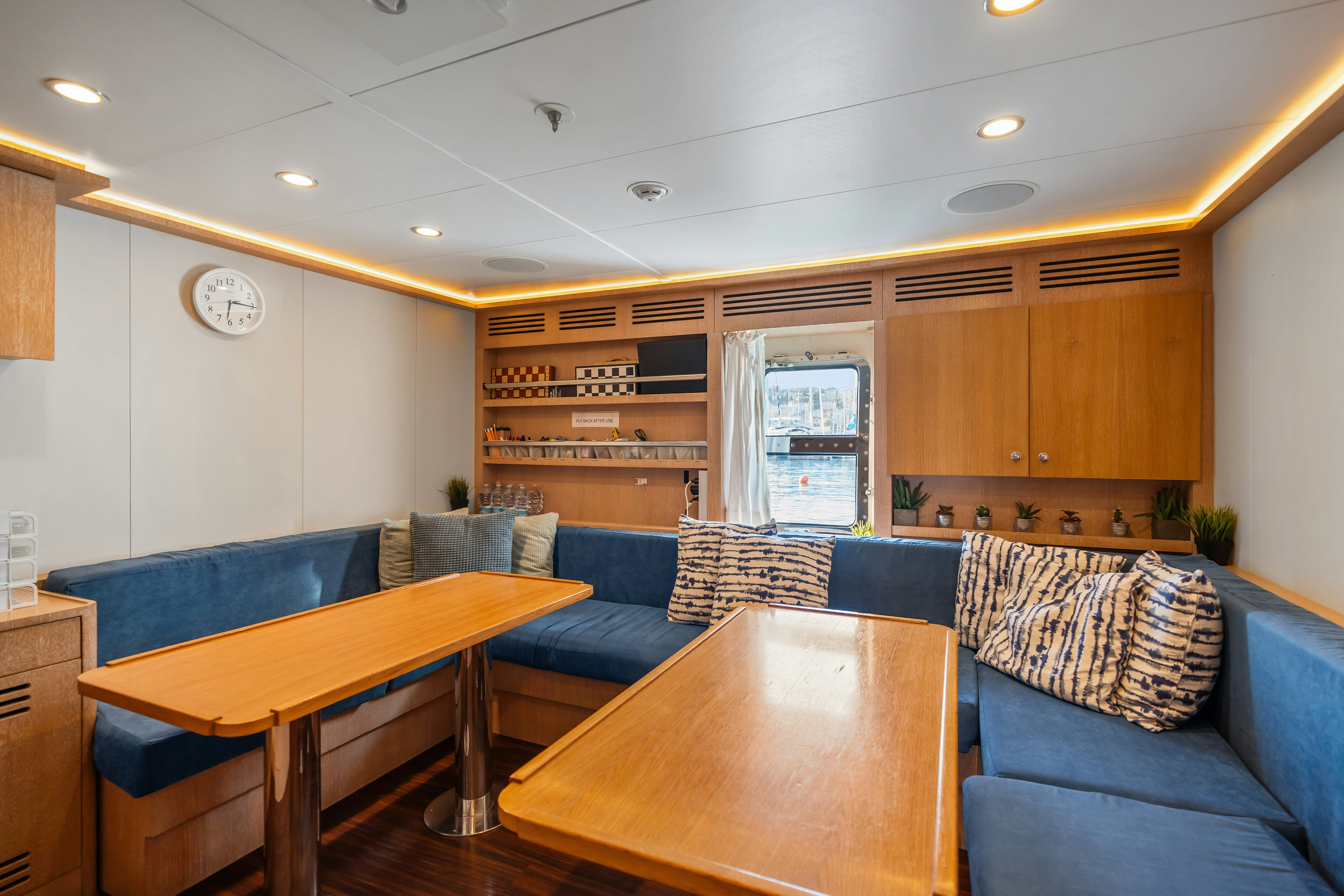 a living room with a couch and a table aboard AXIOMA Yacht for Sale
