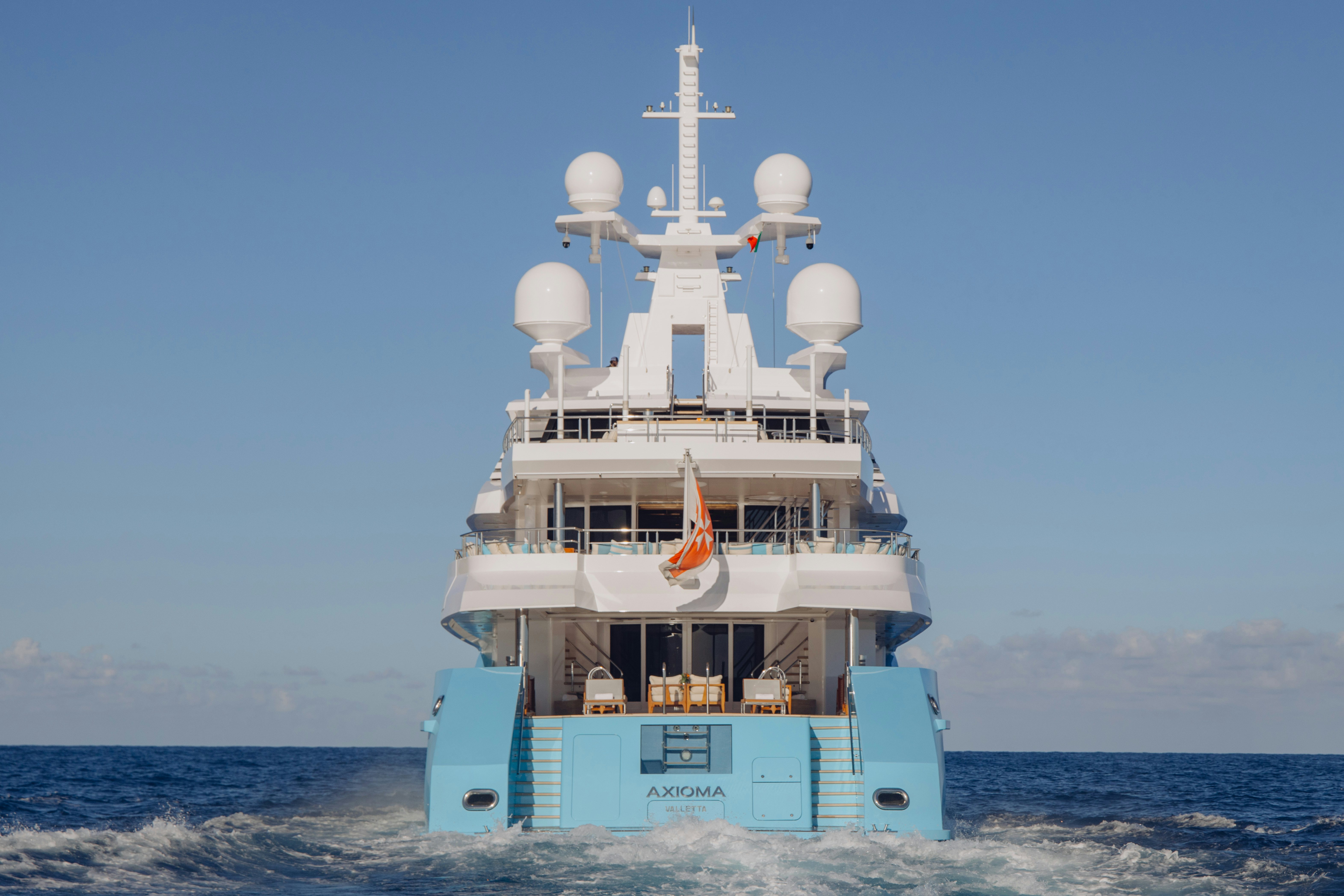 a white and blue boat on the water aboard AXIOMA Yacht for Sale