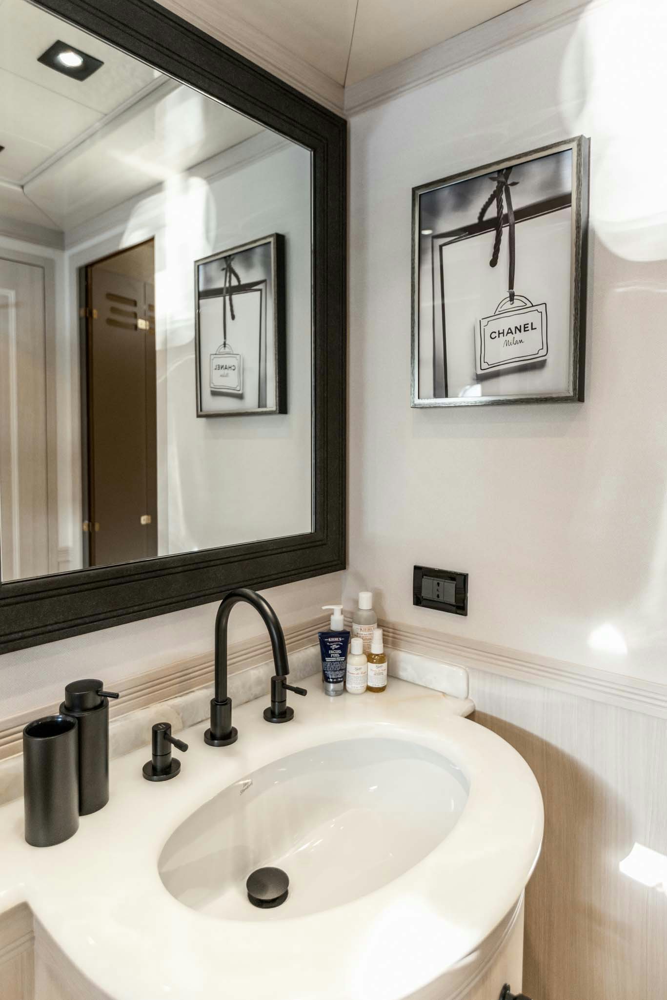 a bathroom with a mirror and a sink aboard MRS GREY Yacht for Charter