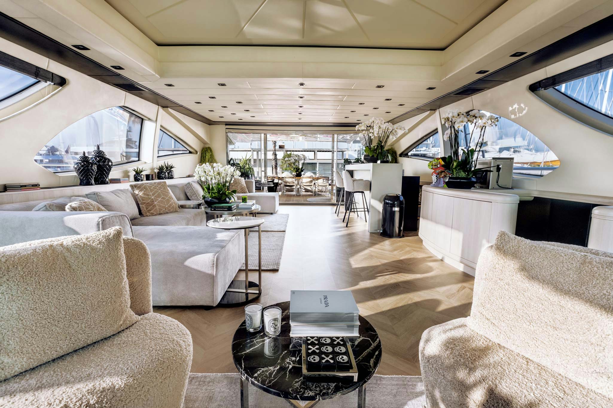 a living room with a large window aboard MRS GREY Yacht for Charter