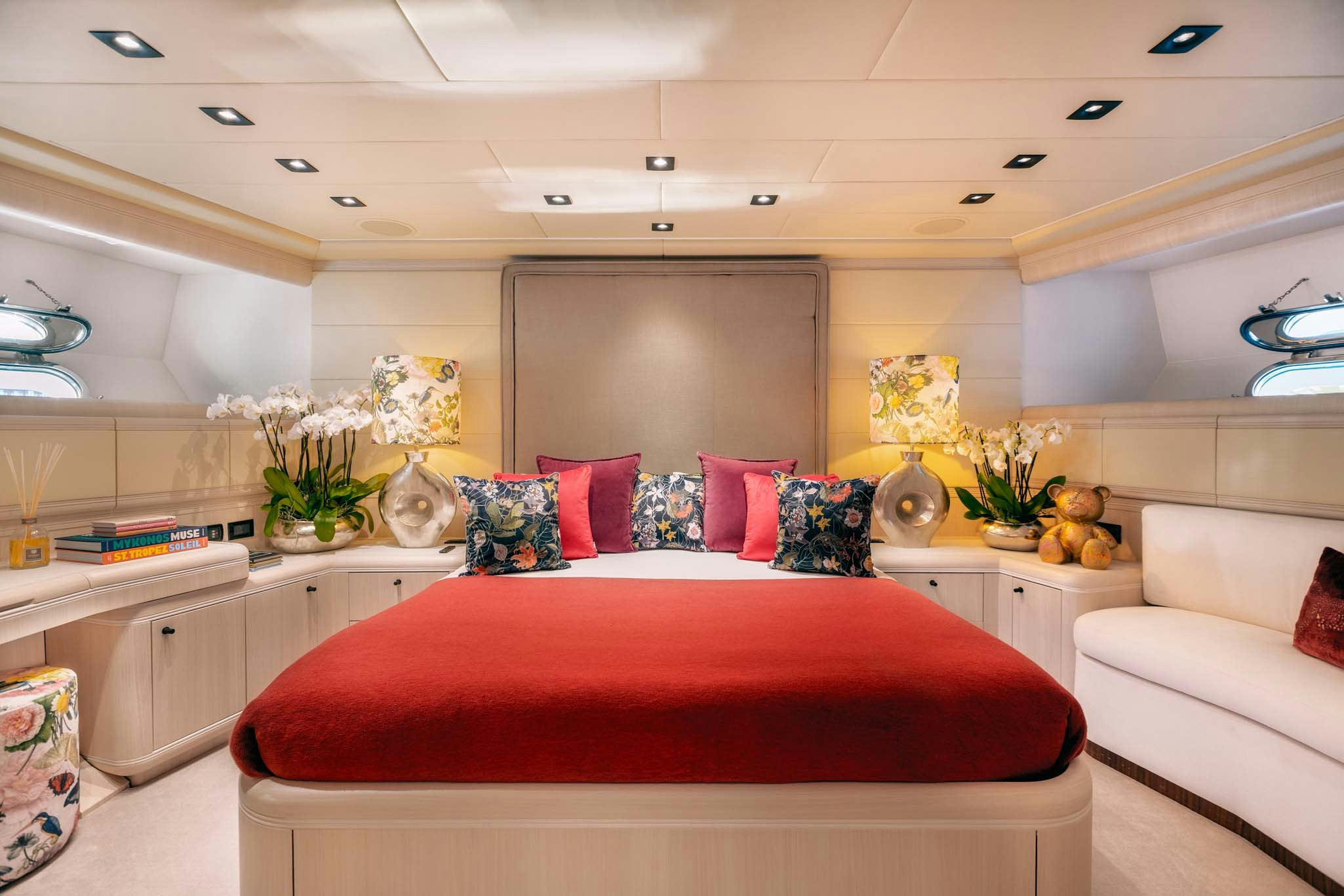a bedroom with a red bed aboard MRS GREY Yacht for Charter