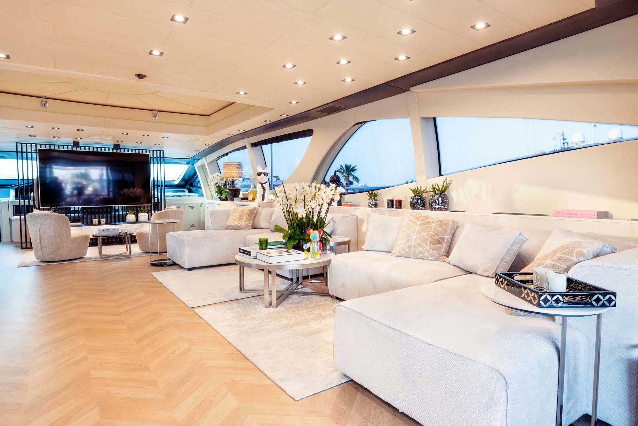 a living room with a large screen aboard MRS GREY Yacht for Charter