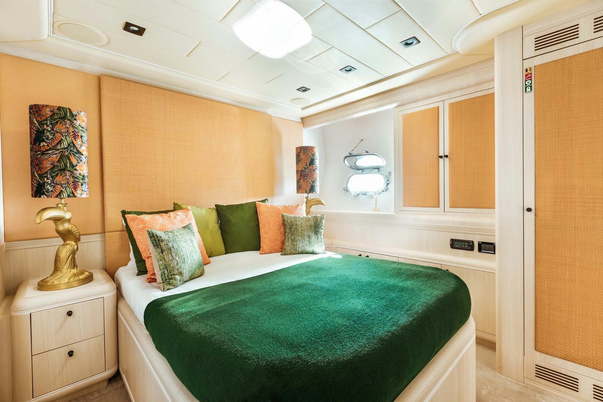 a bedroom with a bed and a lamp aboard MRS GREY Yacht for Charter