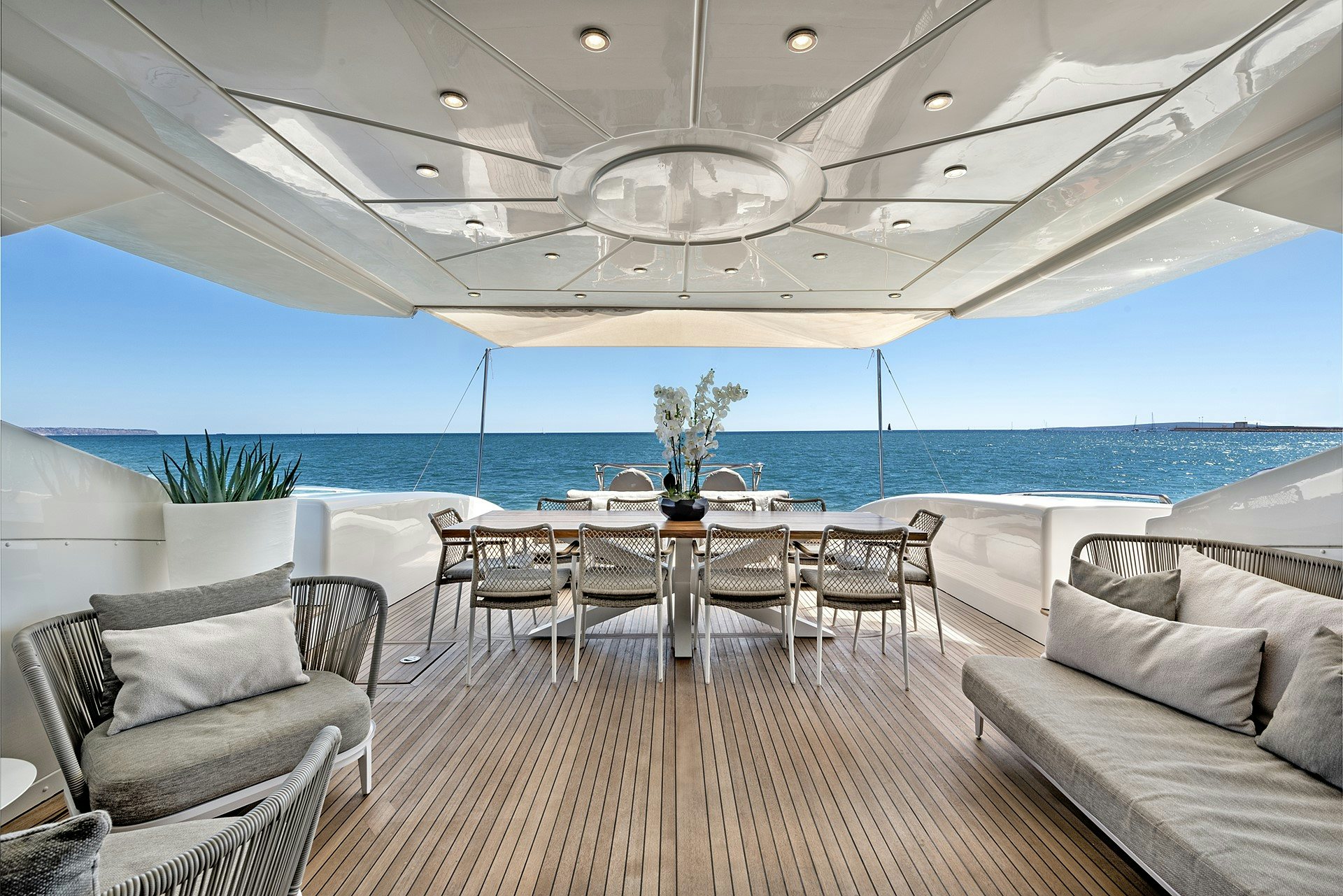 a room with a table chairs and a large body of water aboard MRS GREY Yacht for Charter