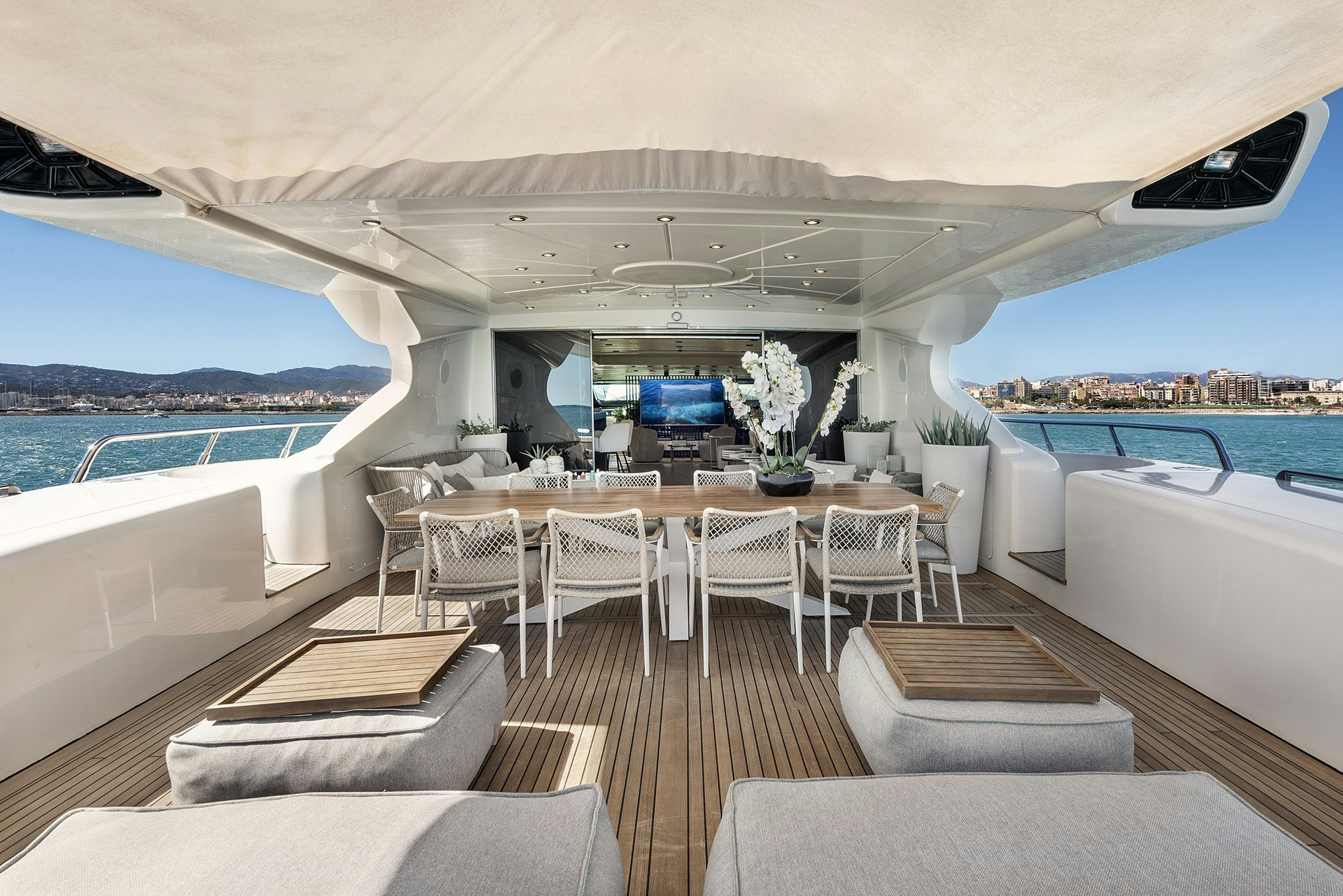 a room with a table chairs and a pool aboard MRS GREY Yacht for Charter