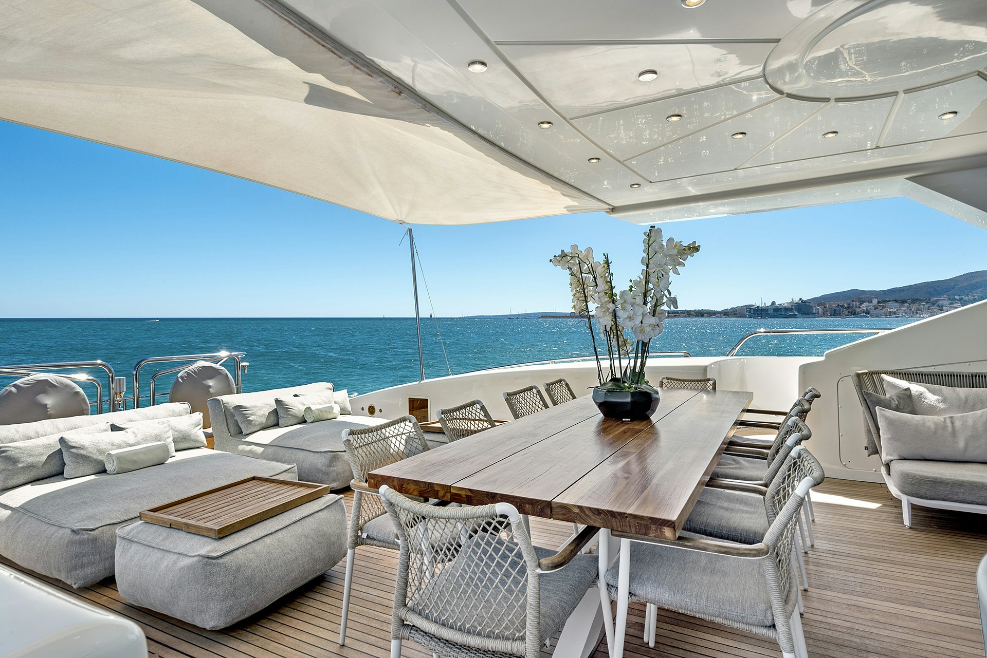 a table and chairs on a deck aboard MRS GREY Yacht for Charter