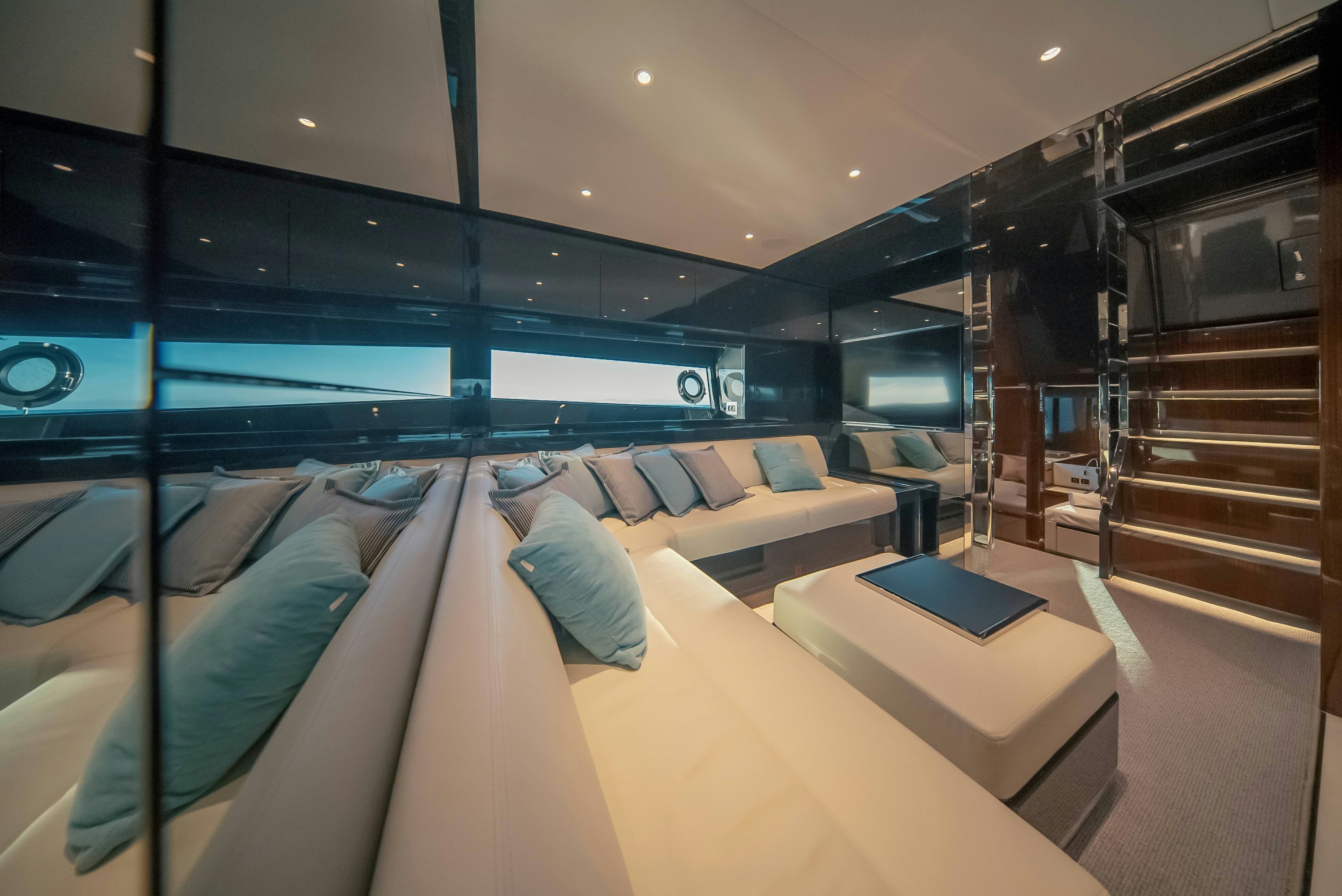 a modern living room with a large sofa and a laptop aboard DIABLE Yacht for Sale