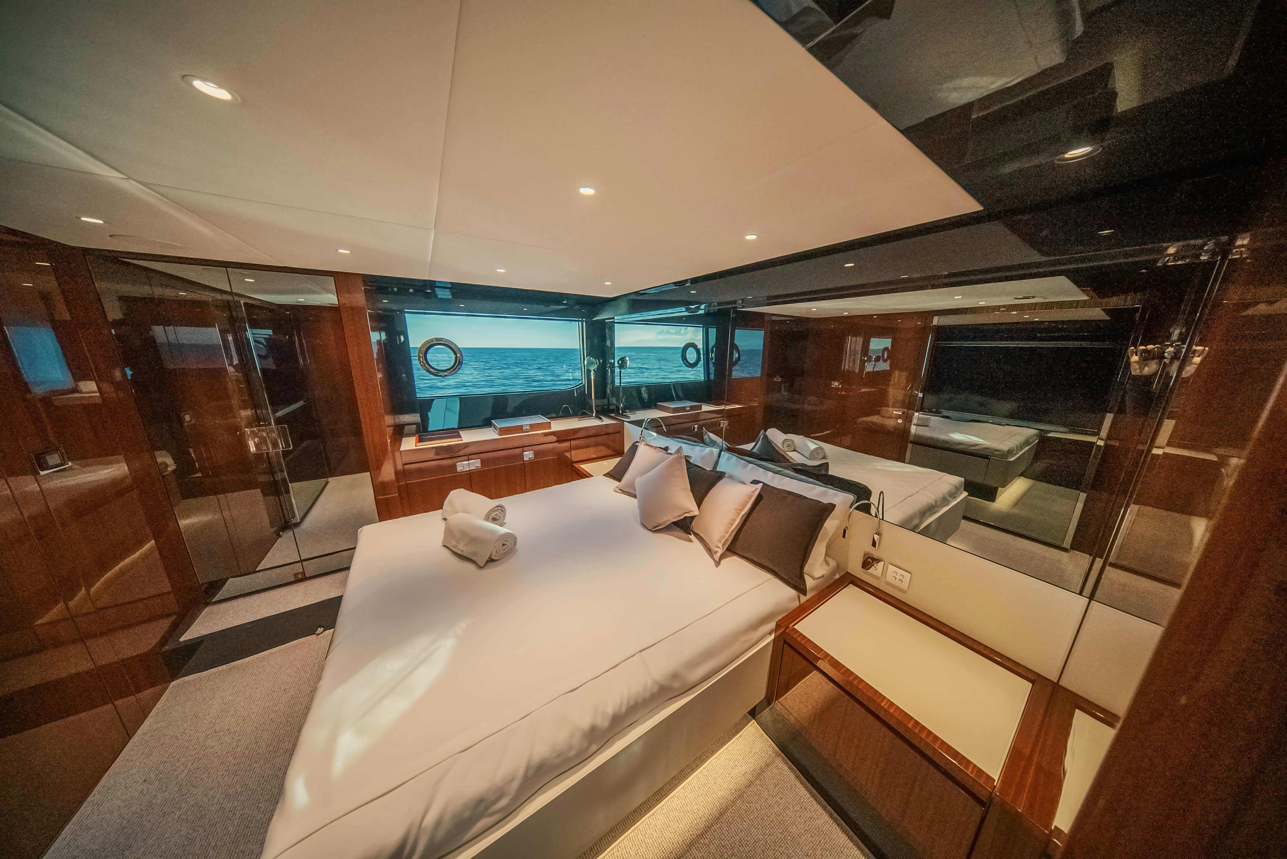 a room with a bed and a window aboard DIABLE Yacht for Sale