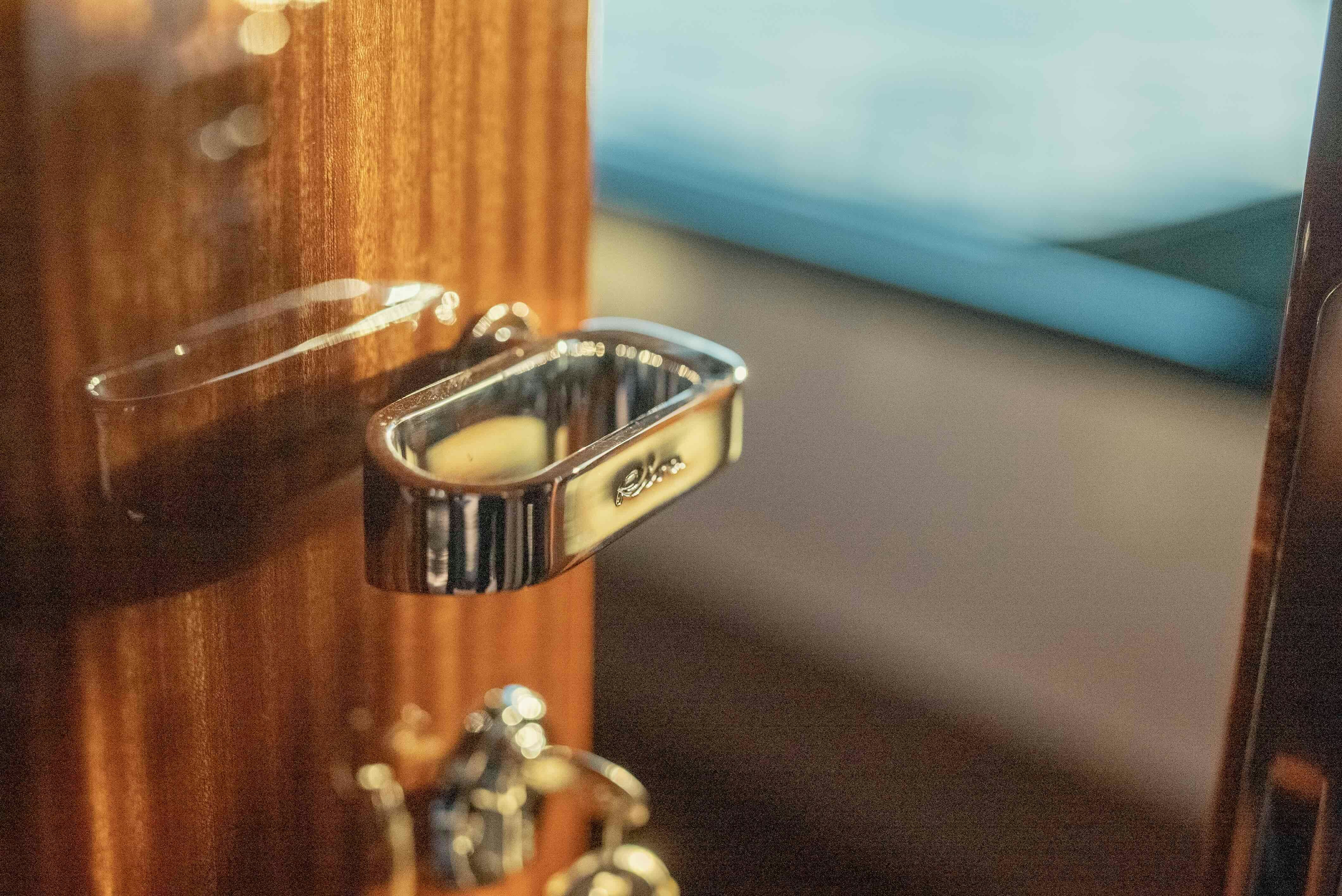 a gold lighter on a wood surface aboard DIABLE Yacht for Sale