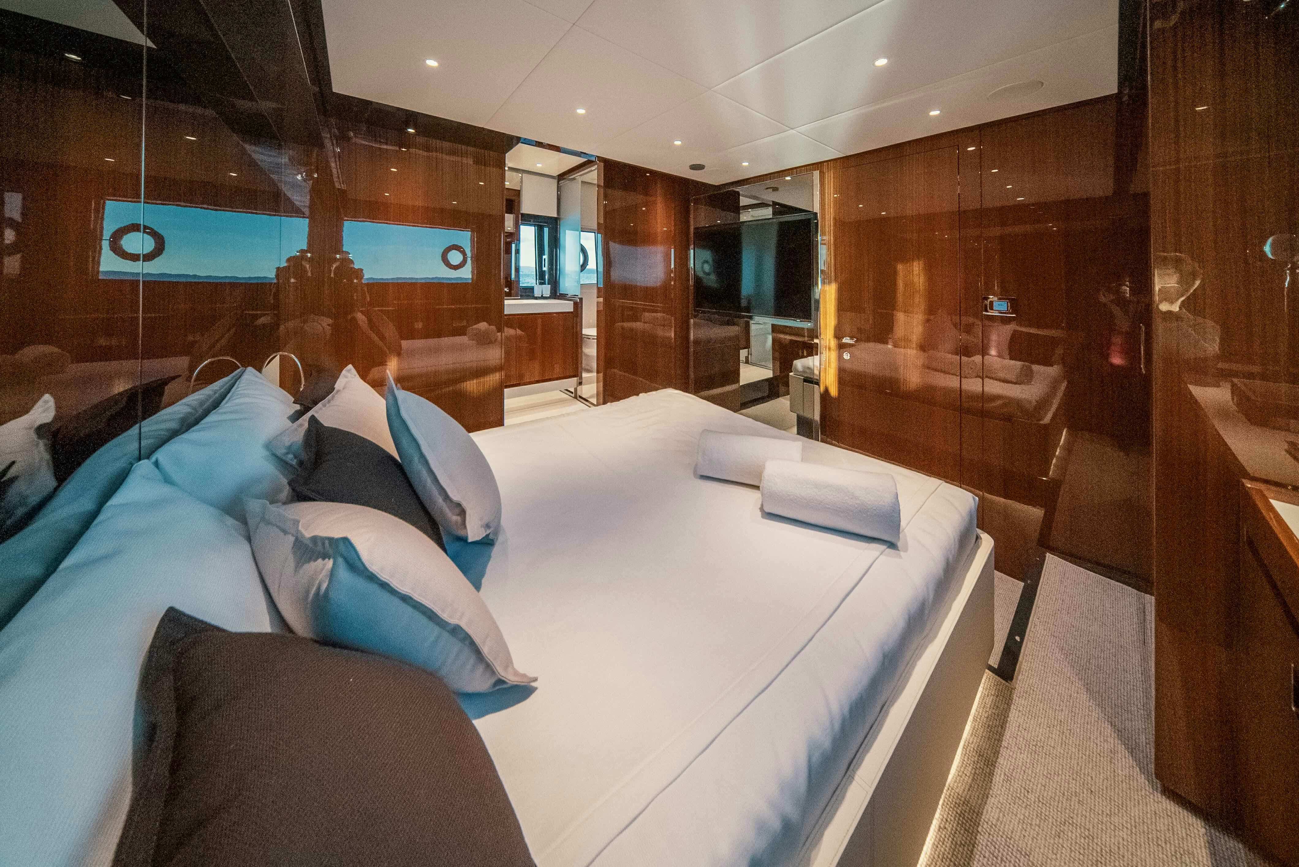 a room with a bed and a desk aboard DIABLE Yacht for Sale