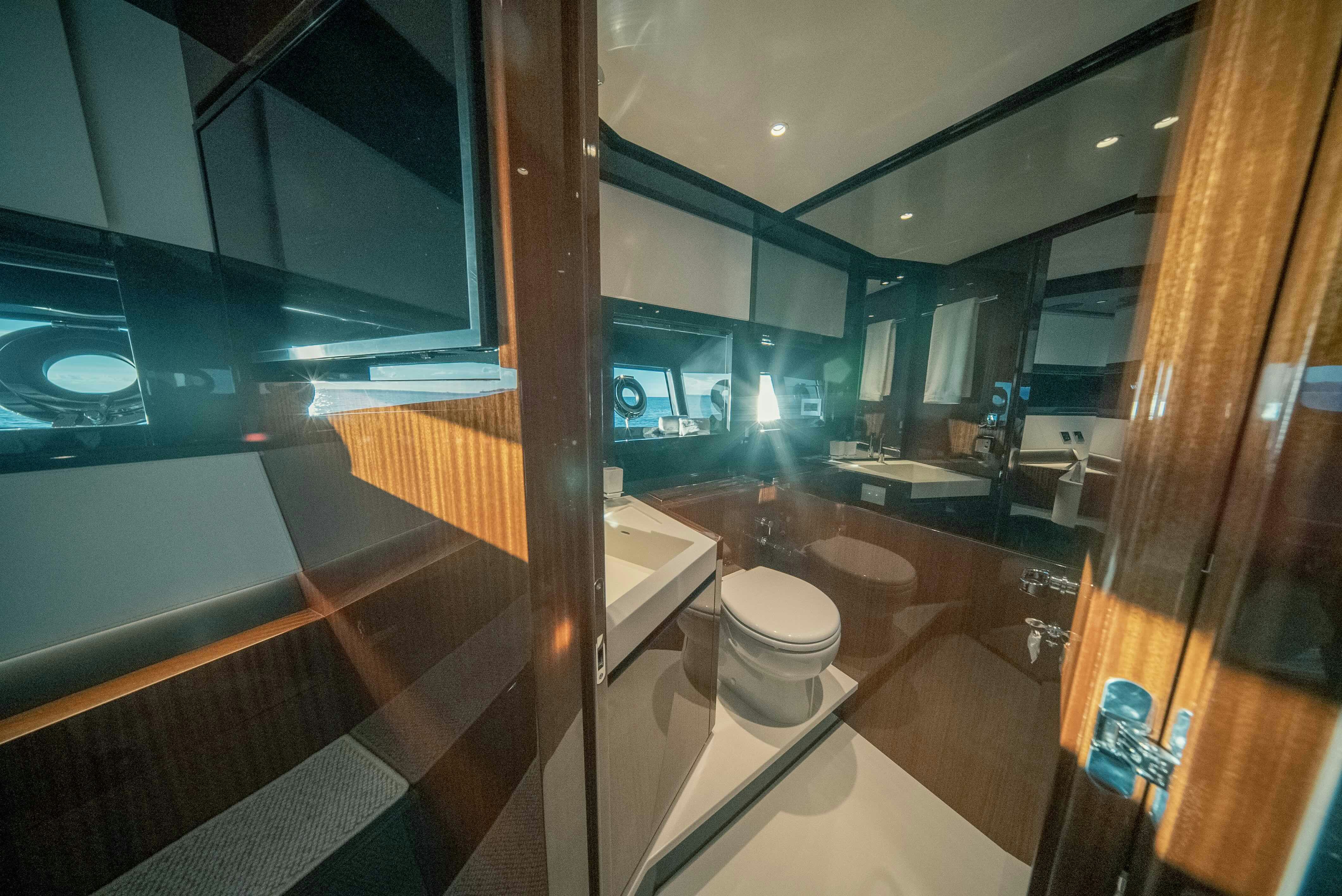 a bathroom with a glass shower aboard DIABLE Yacht for Sale