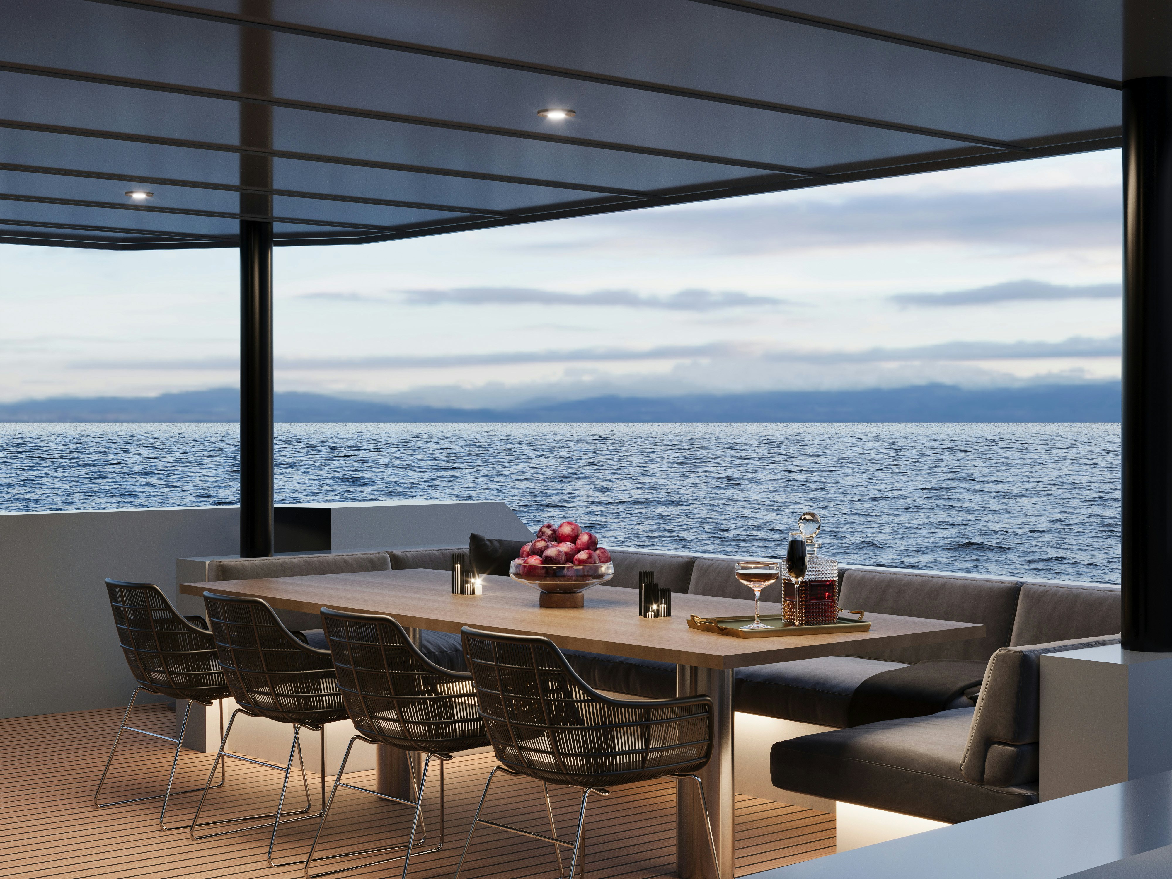 a table with chairs and a view of the ocean aboard PROJECT MAKO SHARK Yacht for Sale