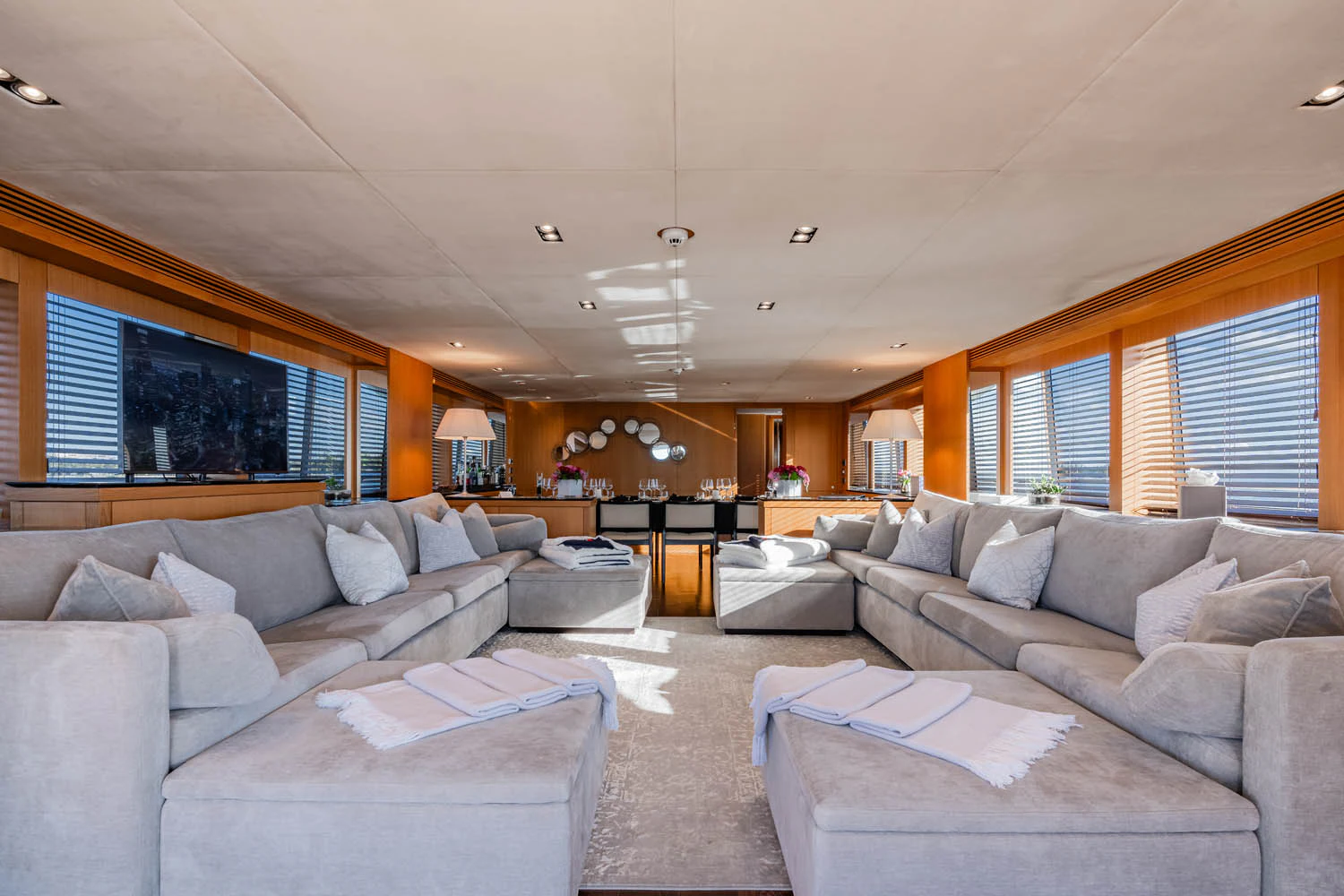 a living room with a couch and a tv aboard LUNA ROSSA Yacht for Charter