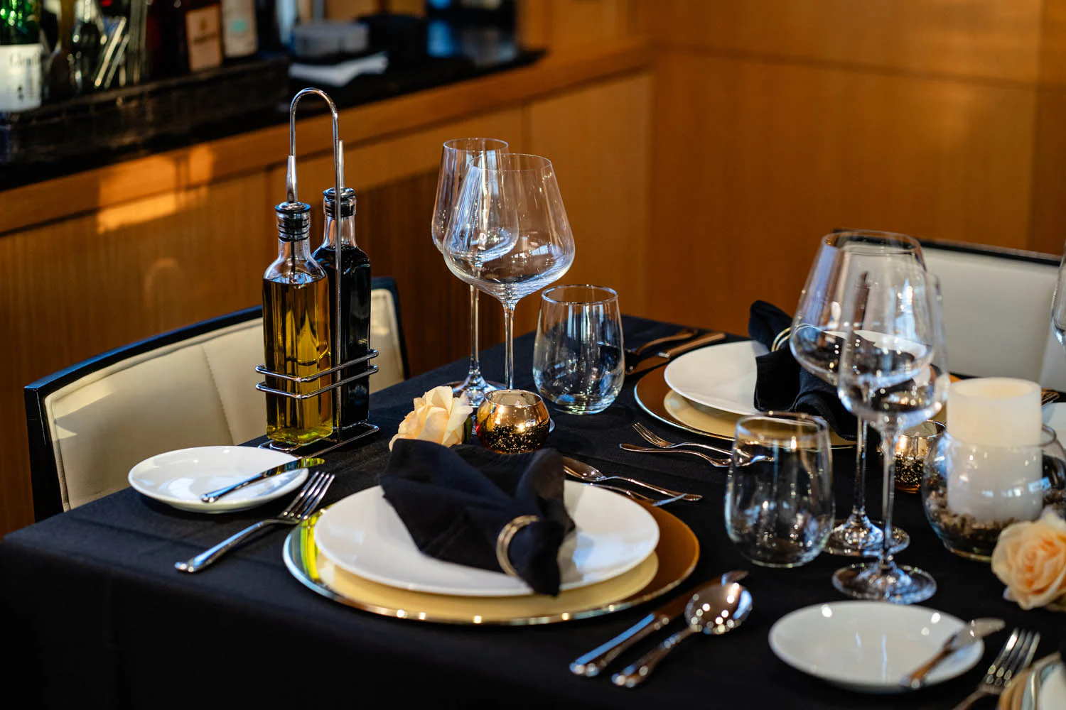 a table with plates and glasses aboard LUNA ROSSA Yacht for Charter
